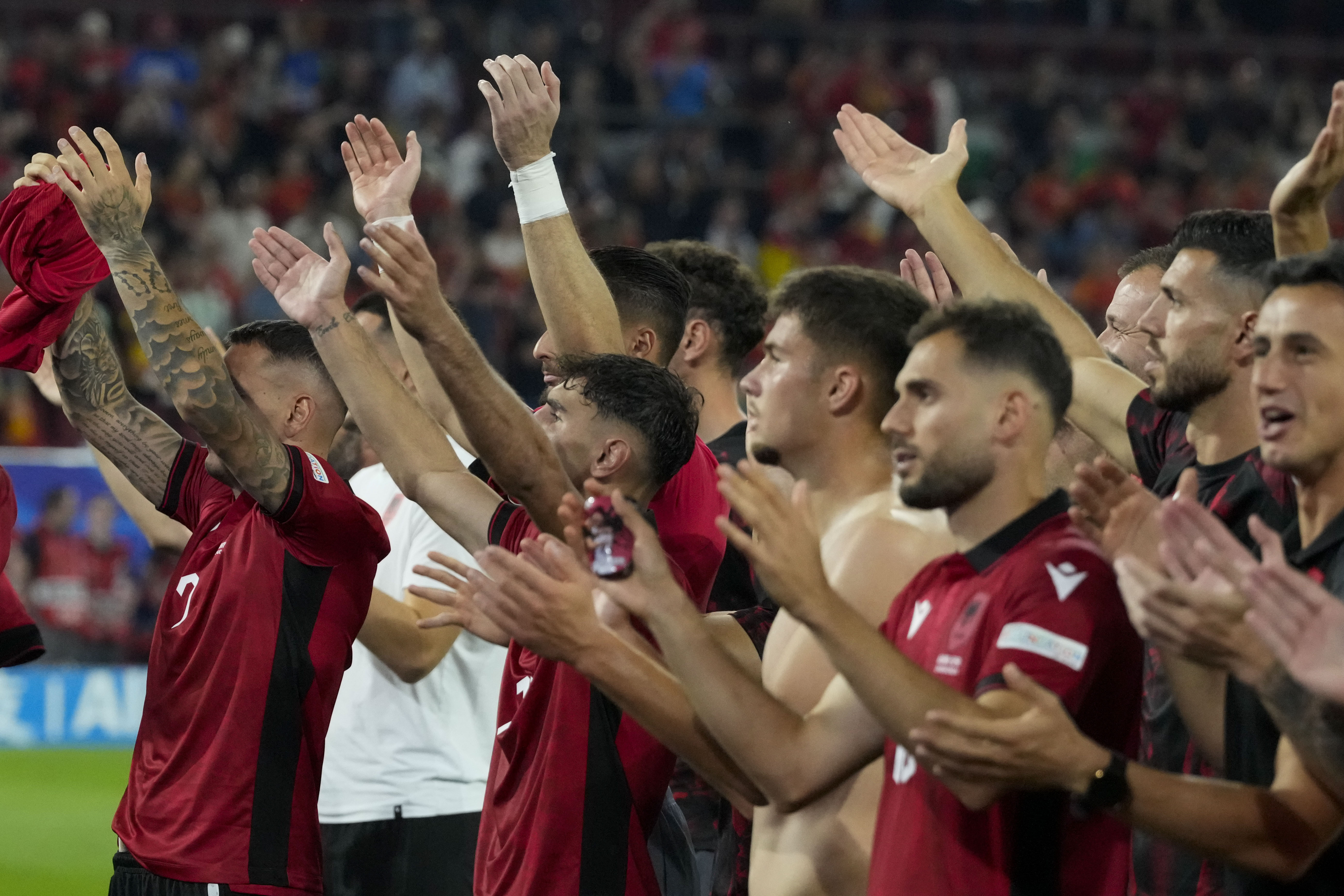 Football players greet fans.
