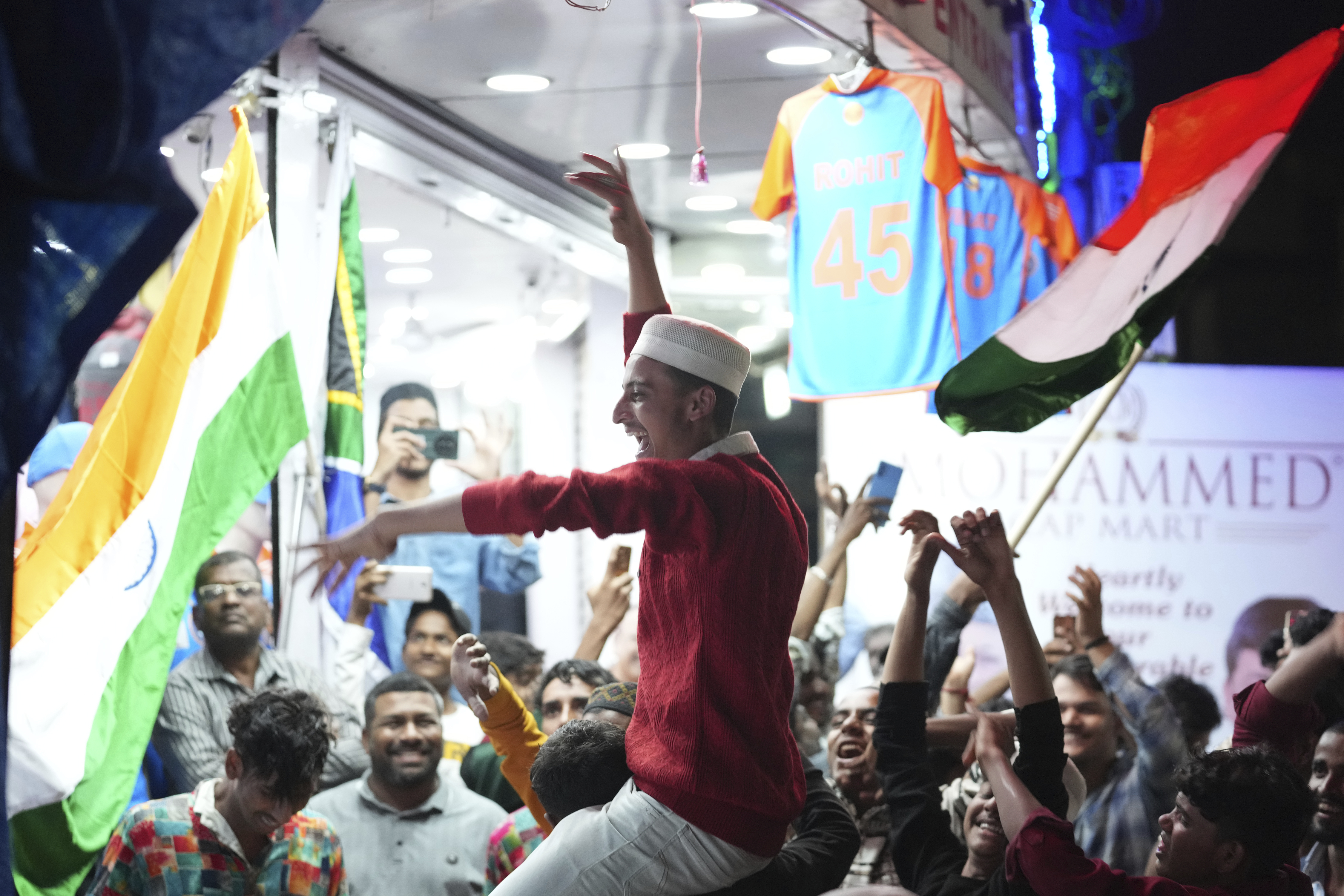 Cricket fans cheer in Hyderabad, India, Saturday, June 29, 2024, as they watch a broadcast of the ICC T20 World Cup final match between India and South Africa in Barbados