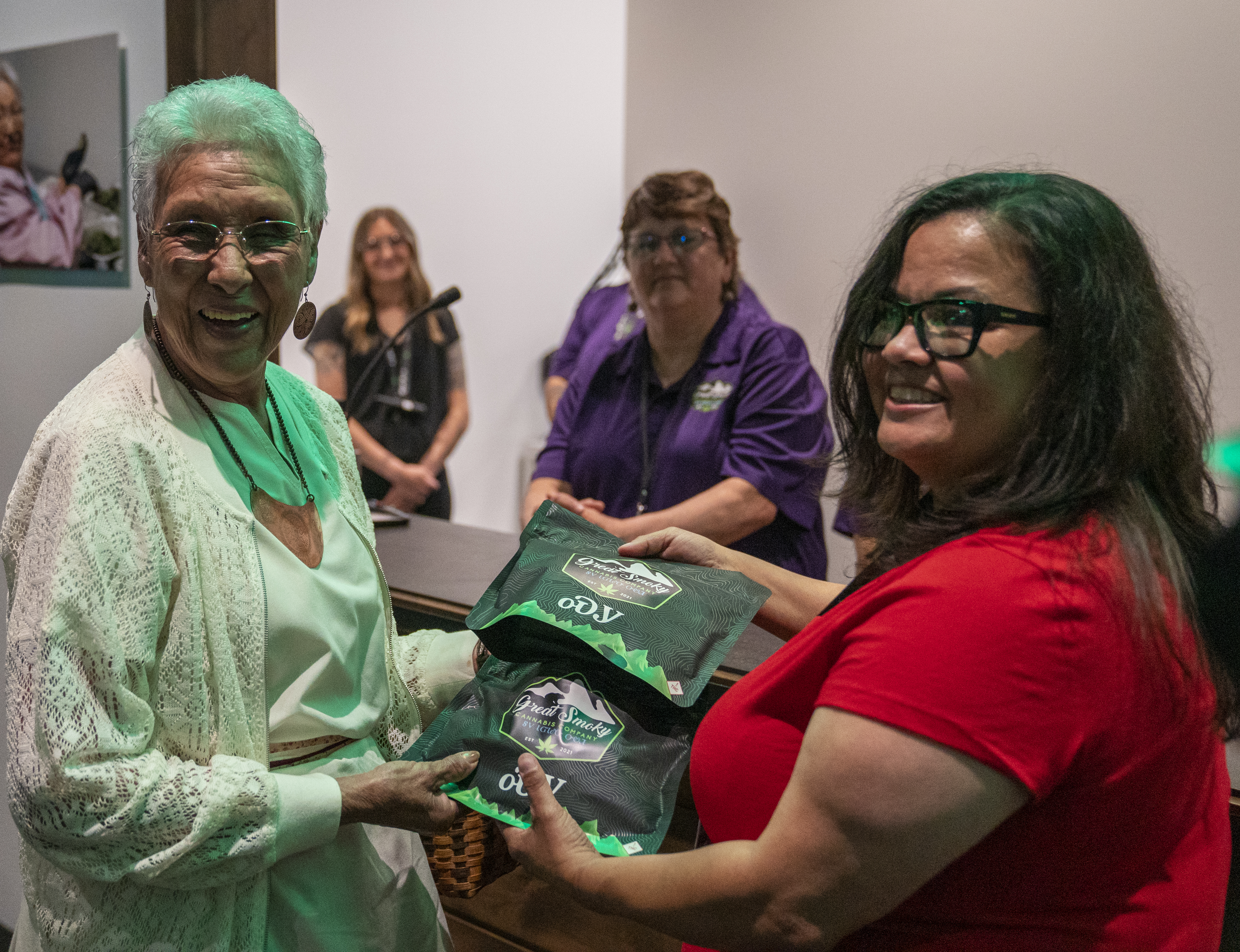 Myrtle Driver and another member of the Eastern Band of Cherokee Indians hold up a package of marijunana infused edibles, labelled in the traditional Cherokee language.