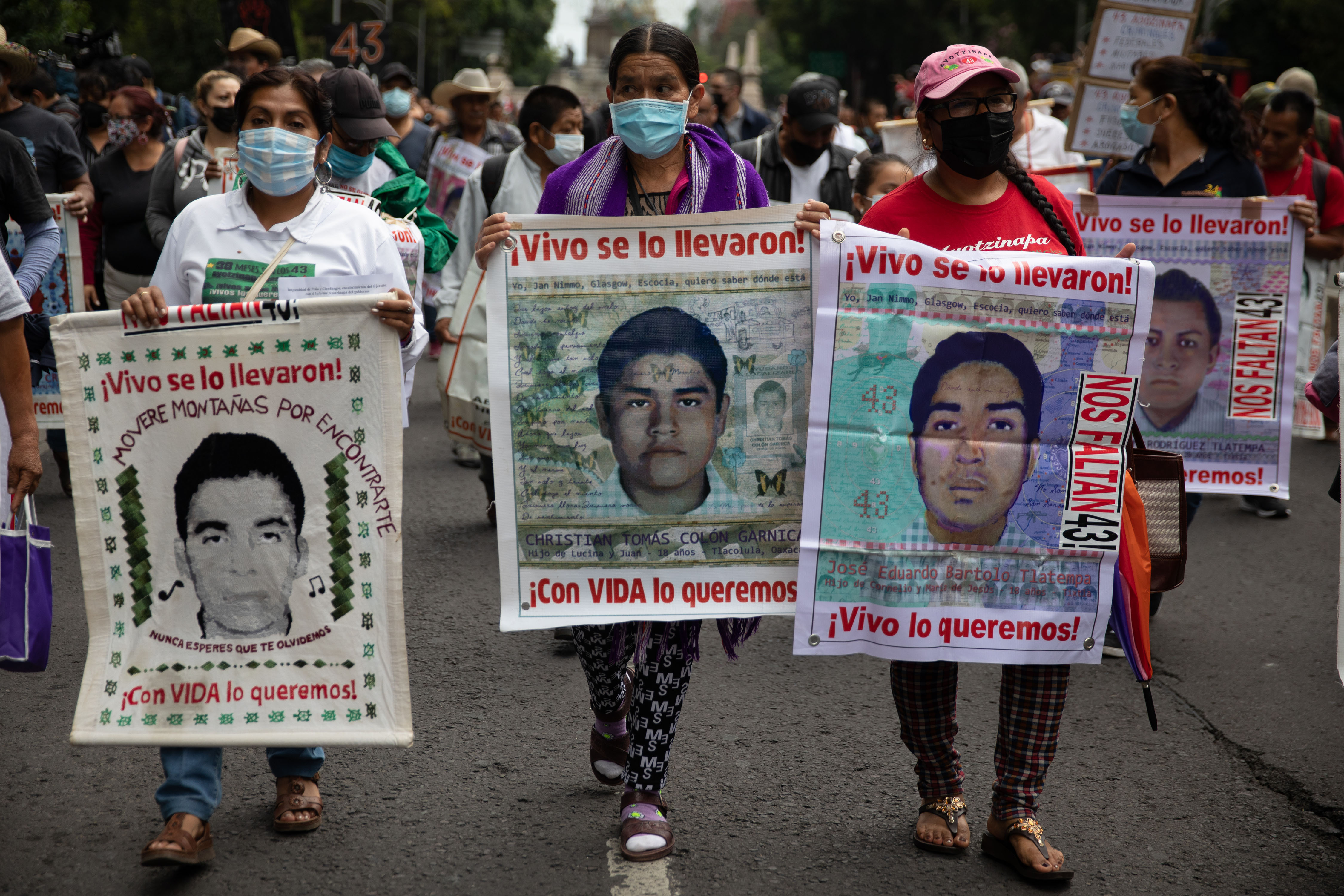 MEXICO CITY, MEXICO - AUGUST 26: Relatives of the 43 missing students from Ayotzinapa, hold portraits during a protest demanding justice for the 43 missing students from the Isidro Burgos rural teachers college, in Mexico City, Mexico on August 26, 2022. Six of the 43 Mexican students disappeared in 2014, were kept alive in a warehouse for days then turned over to the commander of the local army base who ordered their killings, the Mexican government official leading the Truth Commission said Friday. (Photo by Daniel Cardenas/Anadolu Agency via Getty Images)