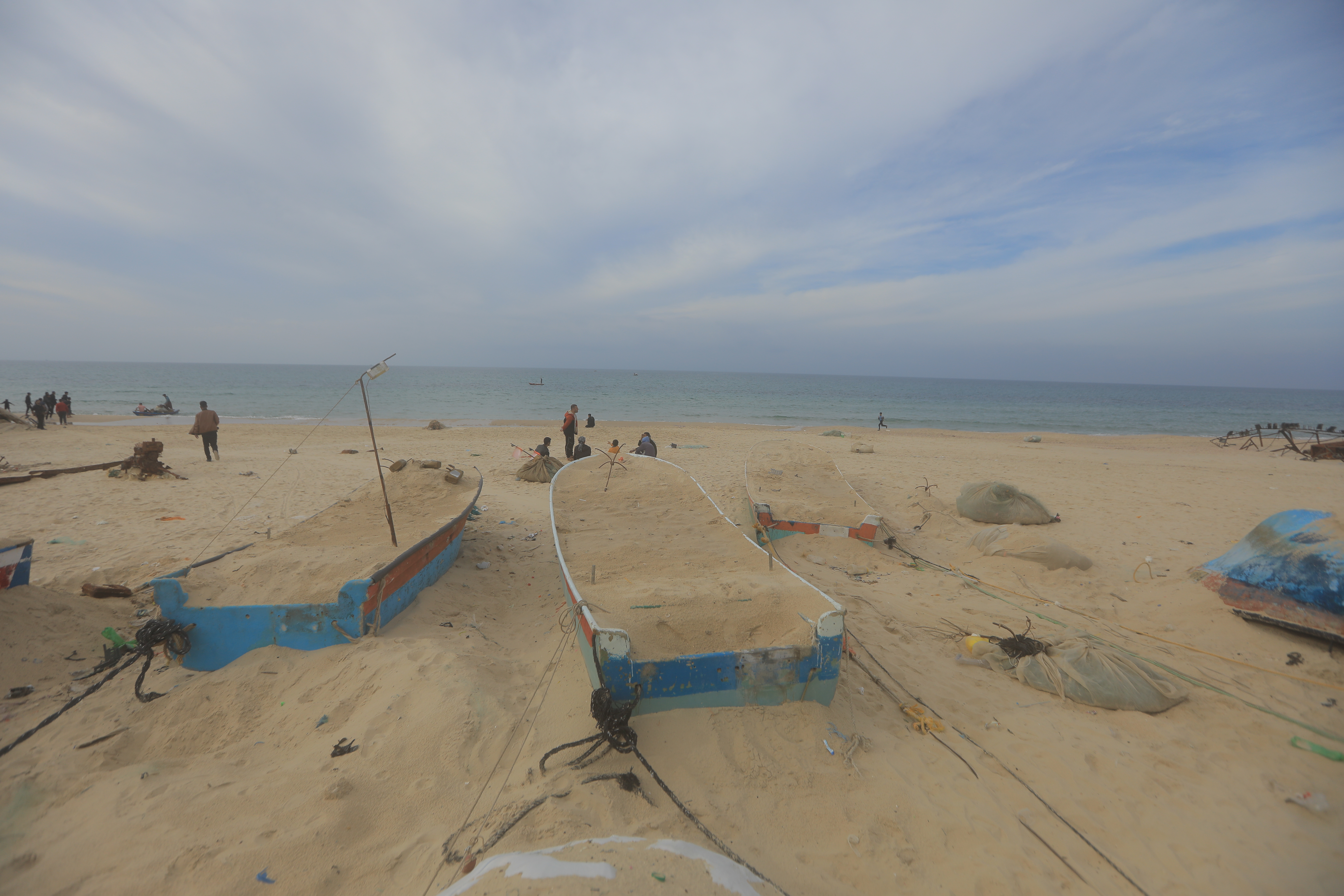 17 December 2023, Palestinian Territories, Rafah: General view of fishing boats after their Palestinian owners covered them with sand to protect them from the phosphorus bombs dropped by the Israeli army. Photo: Mohammed Talatene/dpa (Photo by Mohammed Talatene/picture alliance via Getty Images)