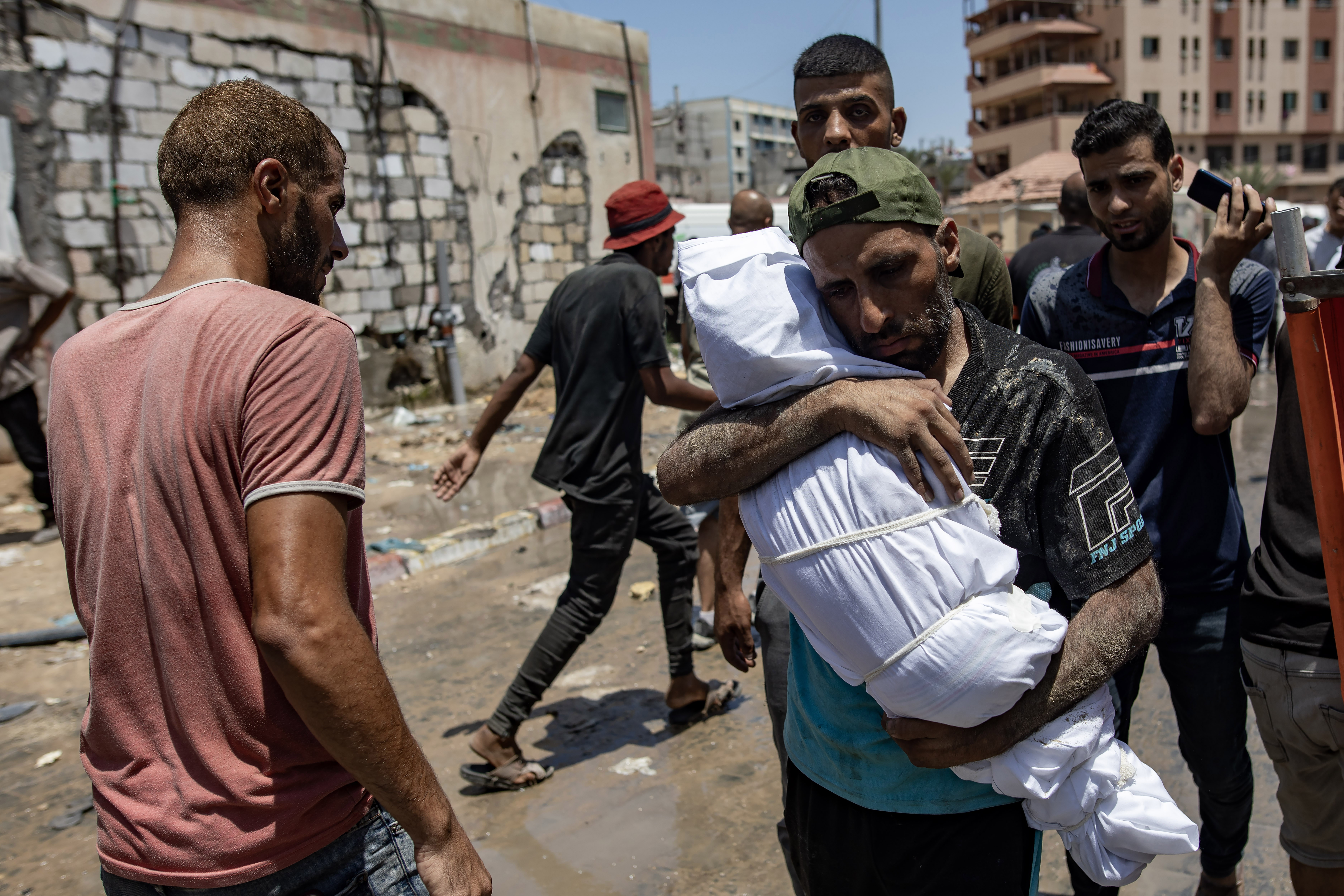 Palestinian carries the body of his son