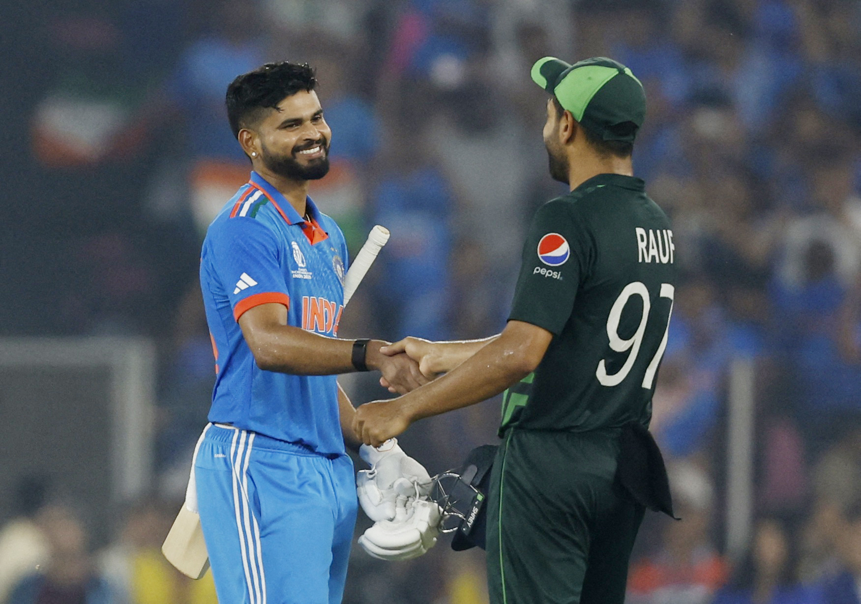 Cricket players shake hands.
