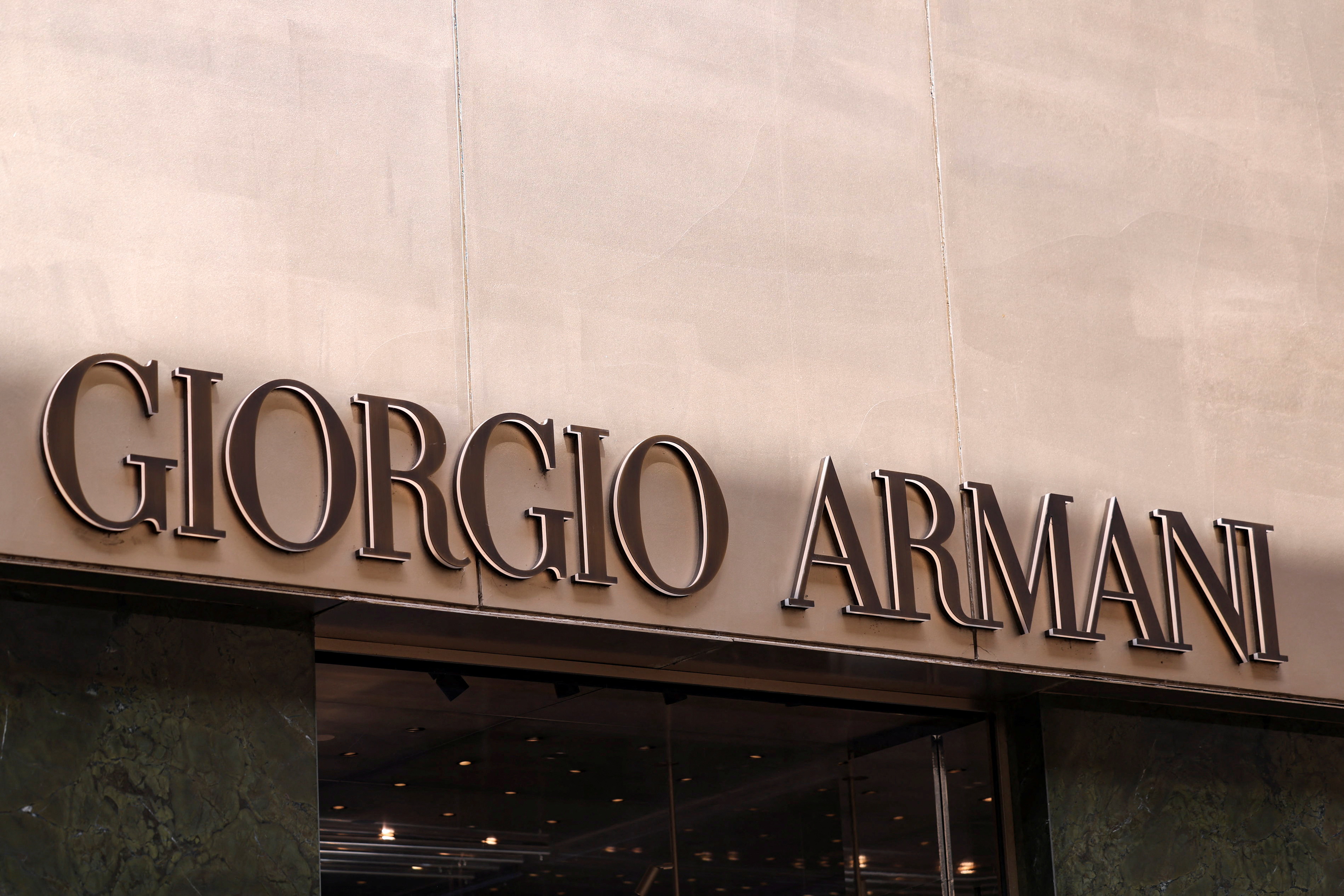 The logo of fashion house Giorgio Armani is seen outside a shop in Milan