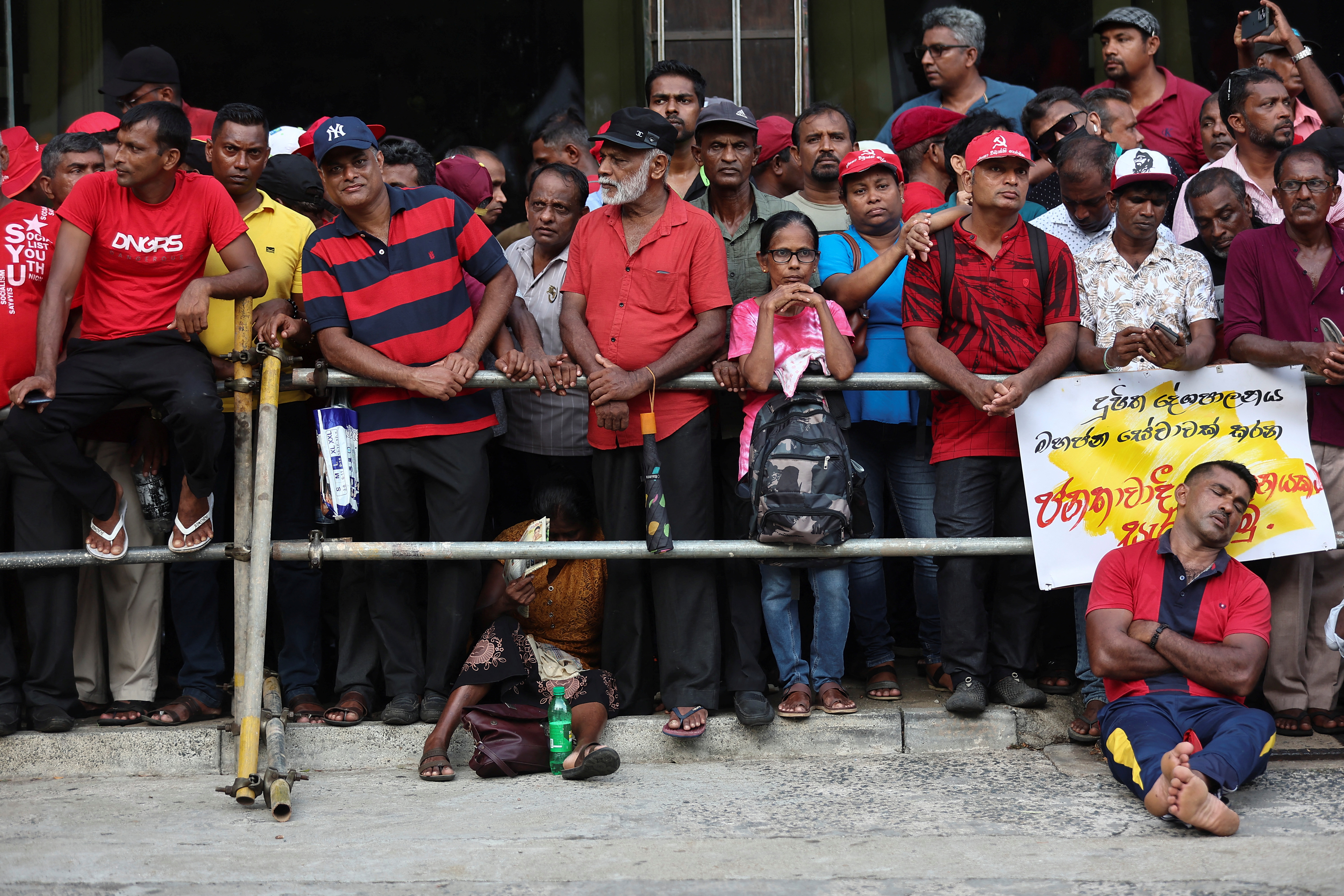 A member of the National People's Power, or Jathika Jana Balawegaya party takes a nap during the rally meeting for the international May Day rally in Colombo, Sri Lanka May 1,2024. REUTERS/Dinuka Liyanawatte