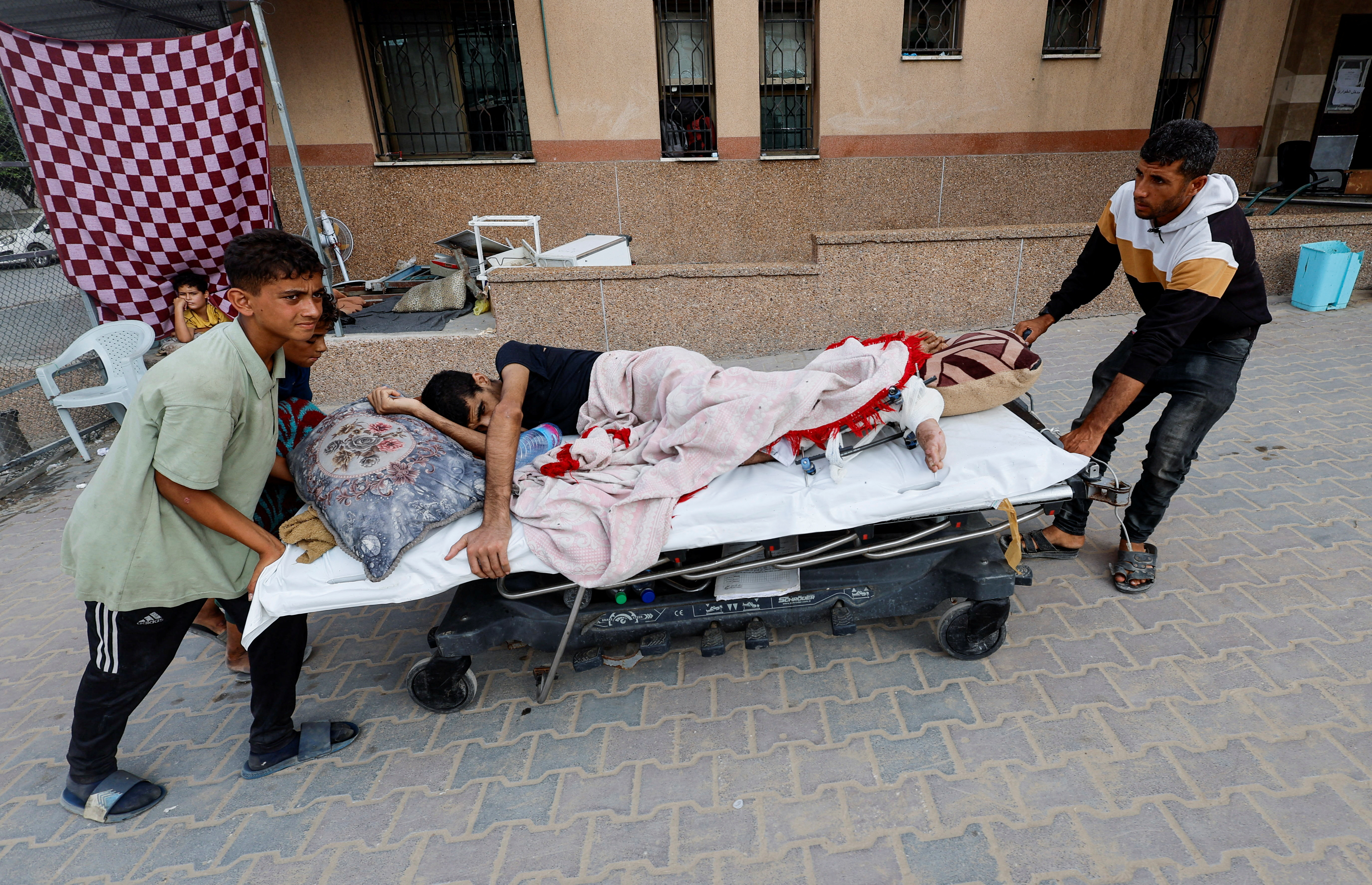 Ali Abu Ismehan, a wounded Palestinian evacuated from the European Hospital after the Israel army ordered residents to leave neighborhoods in the eastern part of Khan Younis, is wheeled on a bed at Nasser hospital, amid the Israel-Hamas conflict, in Khan Younis in the southern Gaza Strip