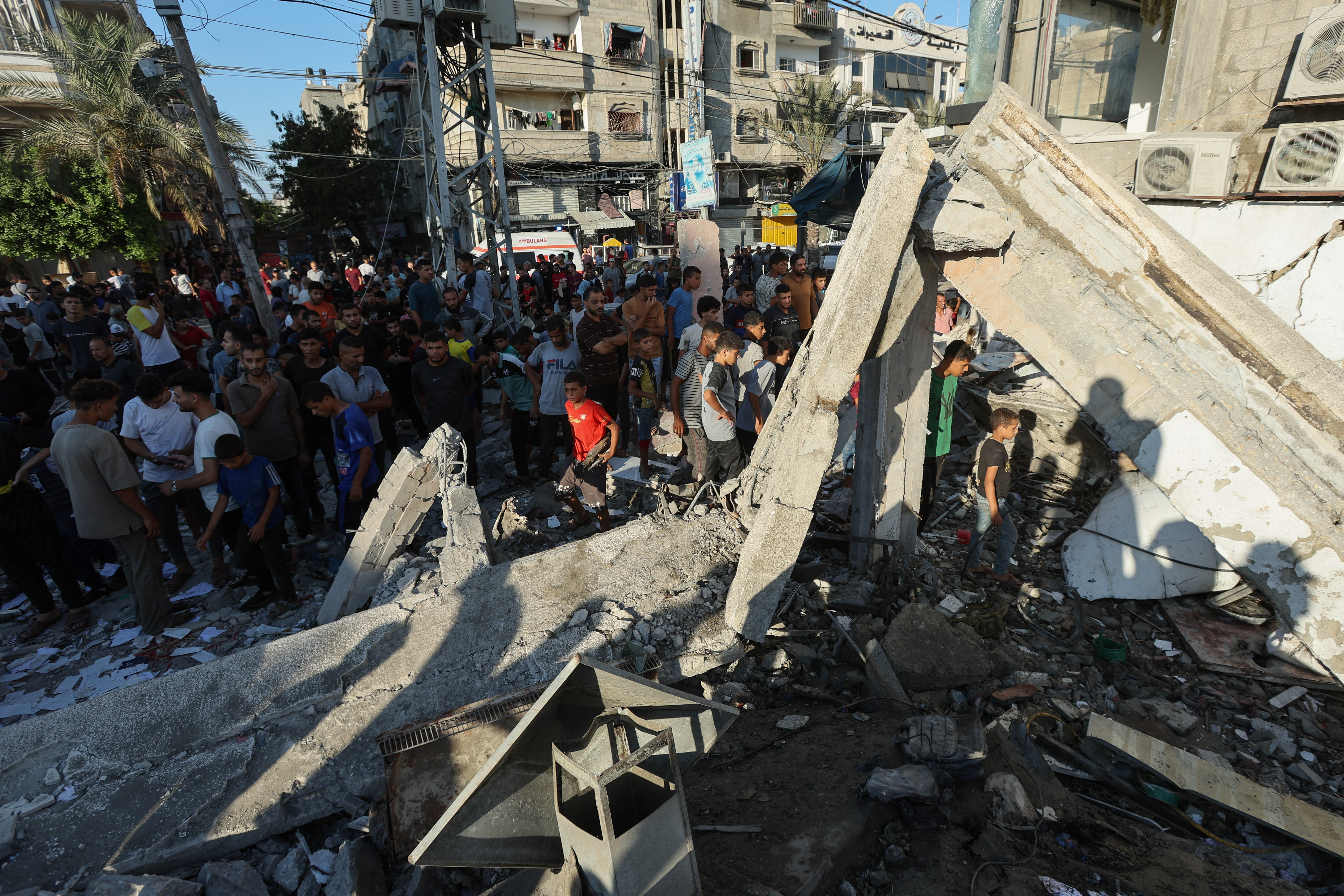 Palestinians gather at the site of an Israeli attack on a UN school sheltering displaced people in central Gaza