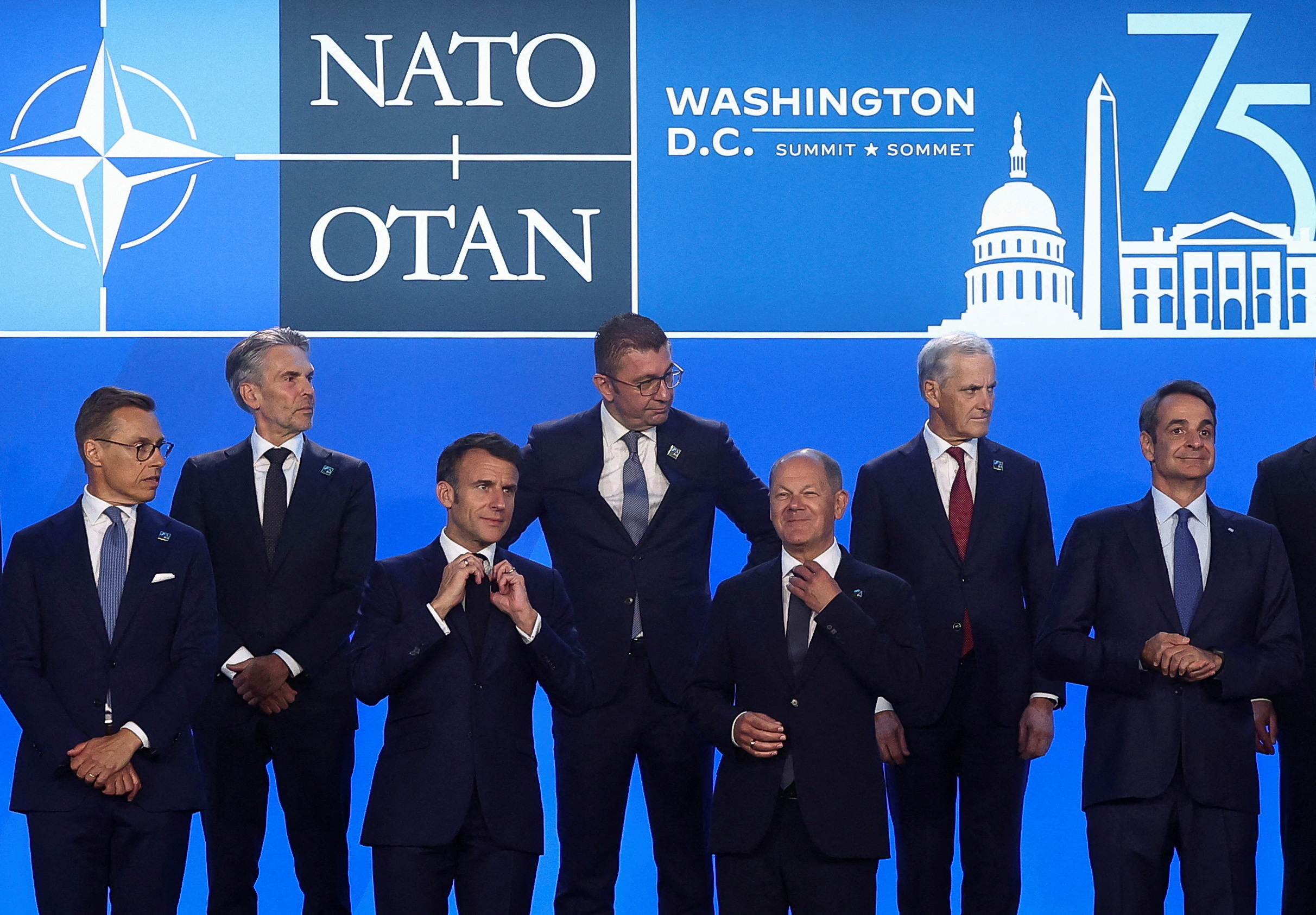 French President Emmanuel Macron, German Chancellor Olaf Scholz and Greek Prime Minister Kiriakos Mitsotakis stand together during NATO's 75th anniversary summit in Washington, U.S., July 10, 2024.
