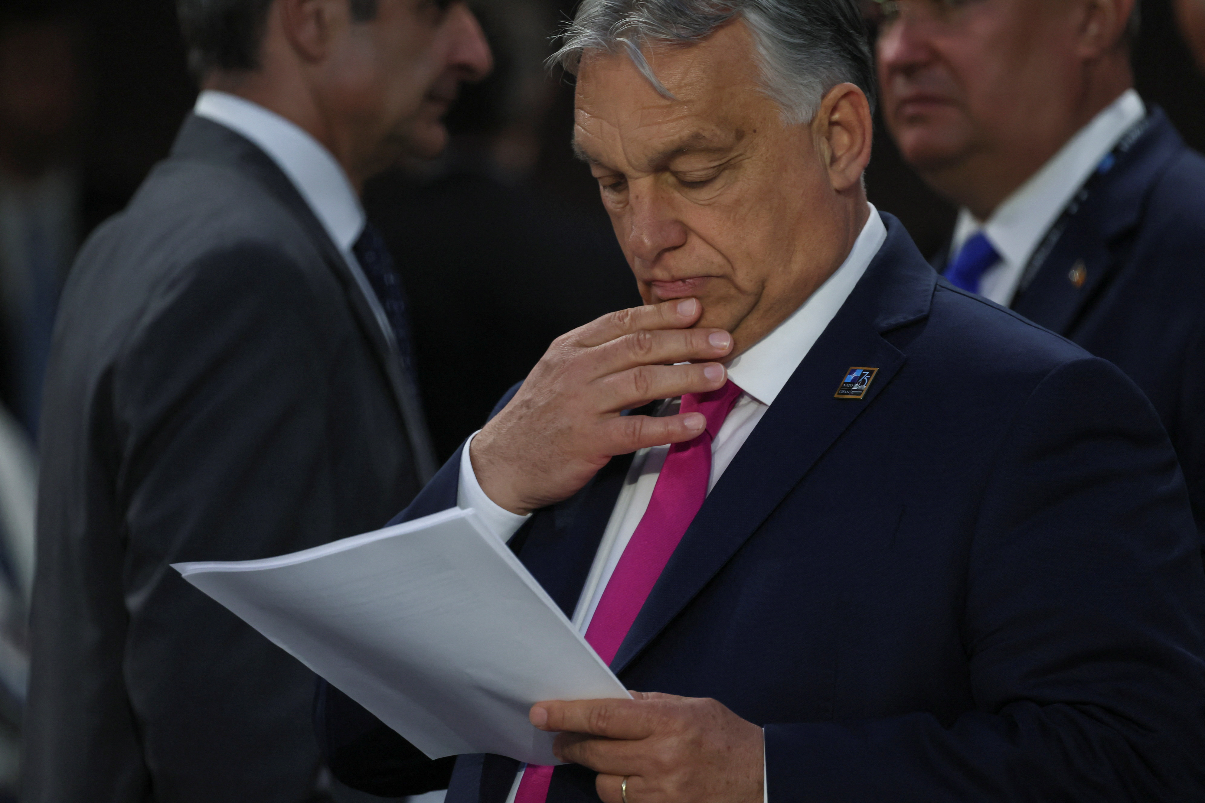 Hungary's Prime Minister Viktor Orban reads a document during NATO's 75th anniversary summit, in Washington, U.S., July 11, 2024. REUTERS/Leah Millis