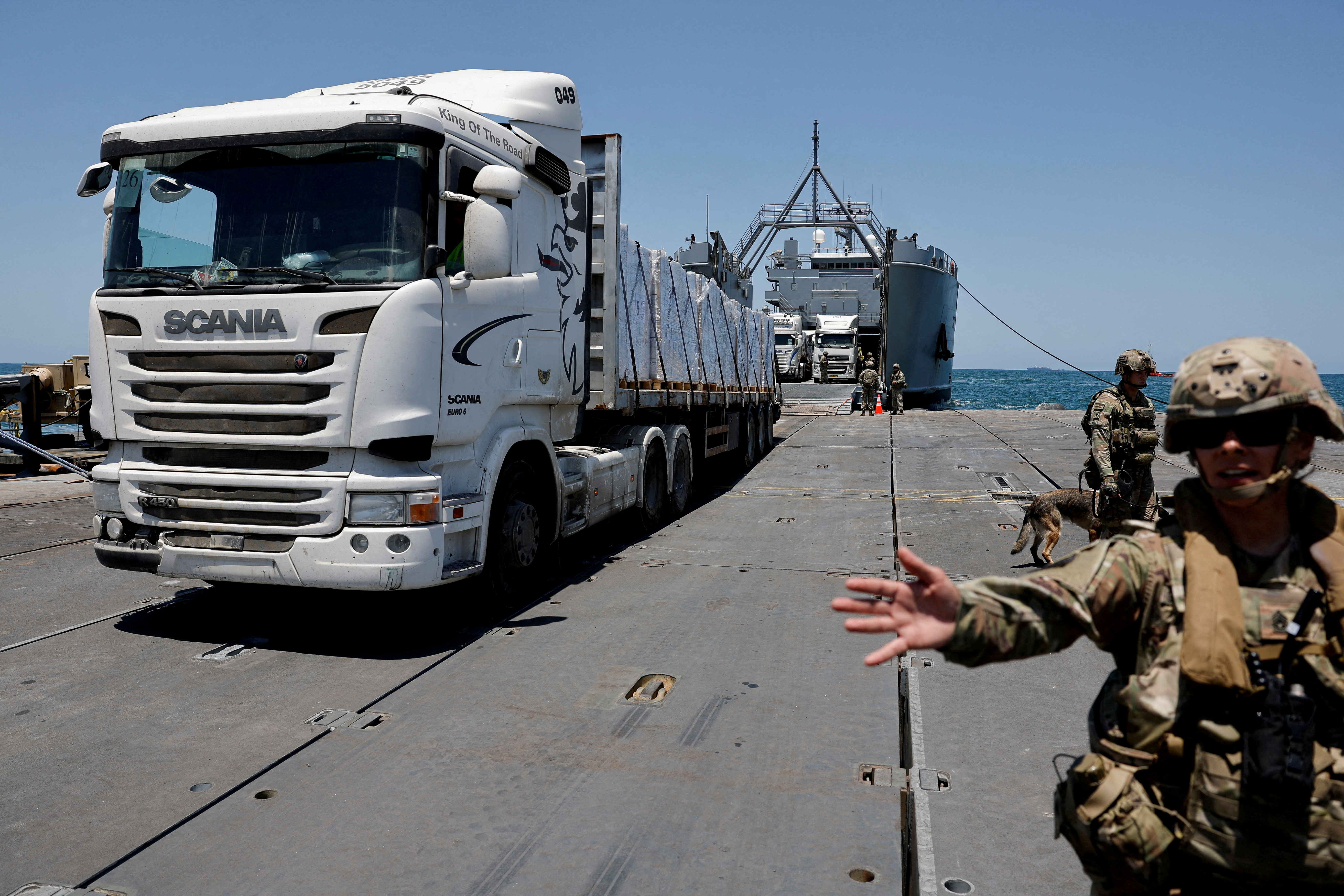 A truck carries humanitarian aid across Trident Pier, a temporary pier to deliver aid, off the Gaza Strip