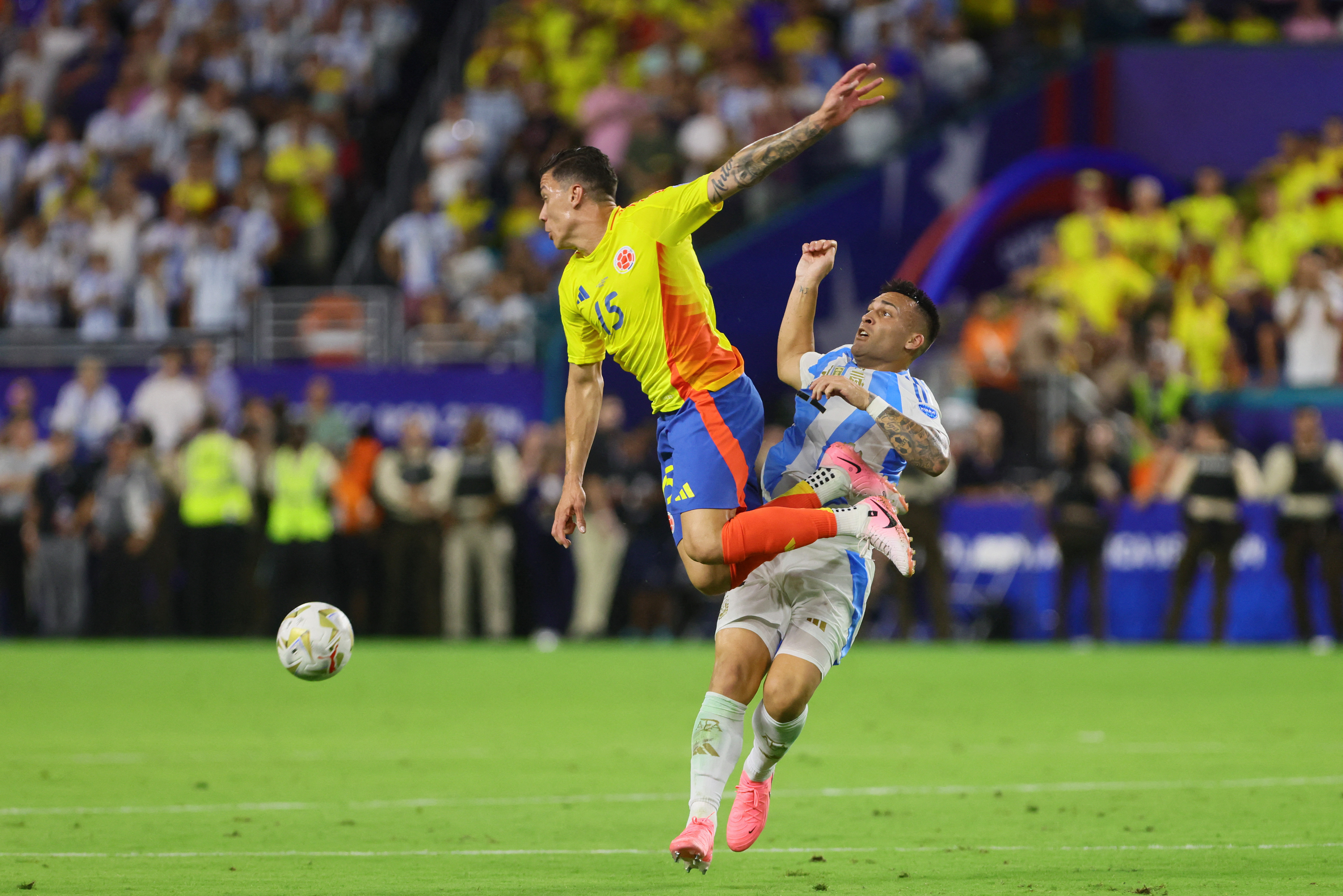 Colombia midfielder Andres Uribe (15) and Argentina forward Lautaro Martinez (22) battle for possession during the second half of extra time of the Copa America
