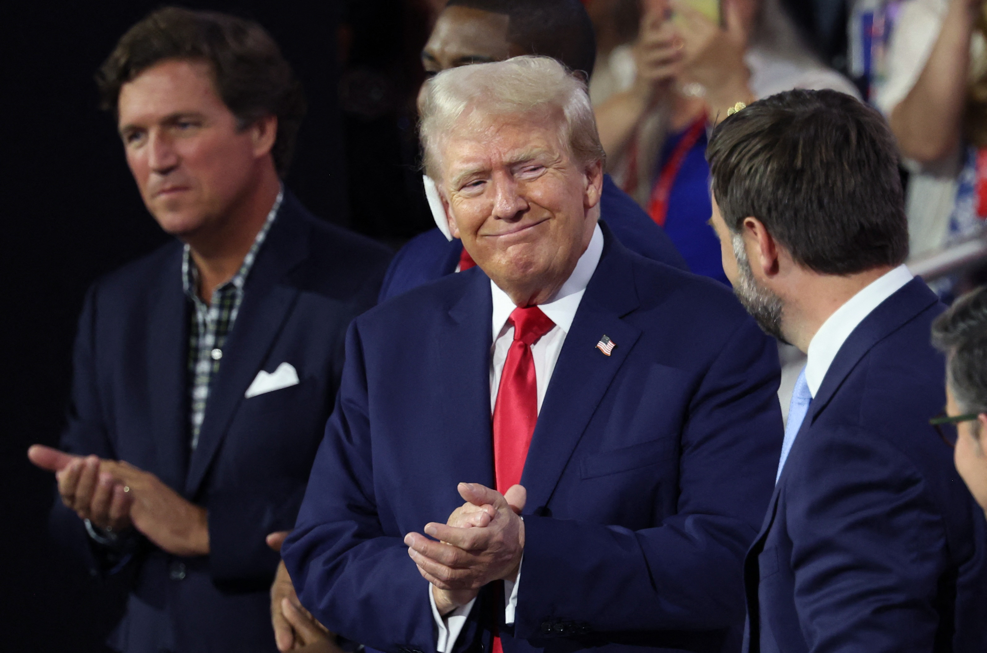 Former US President Donald Trump claps at the Republican National Convention