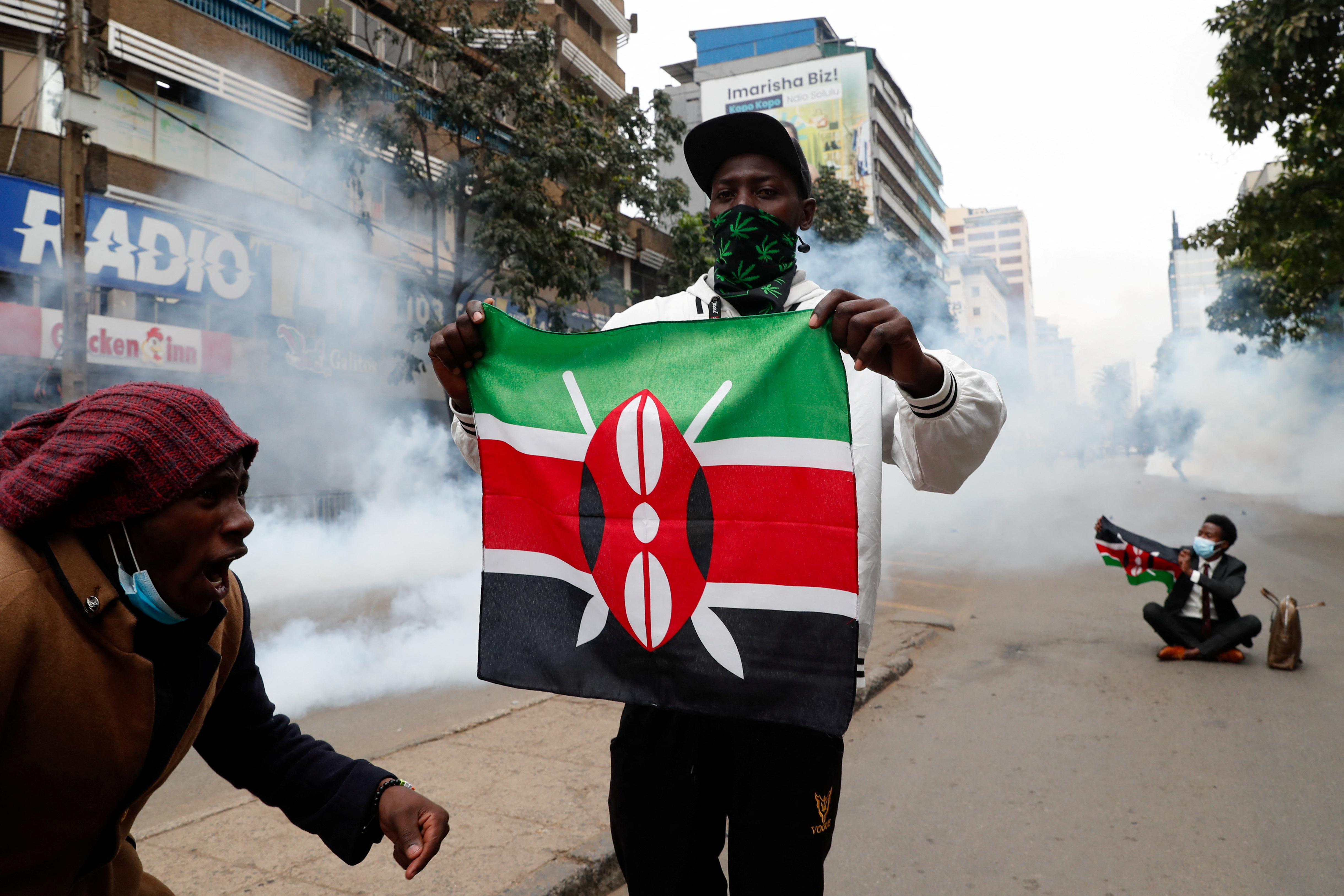 Protesters hold flags as they participate in an anti-government demonstration