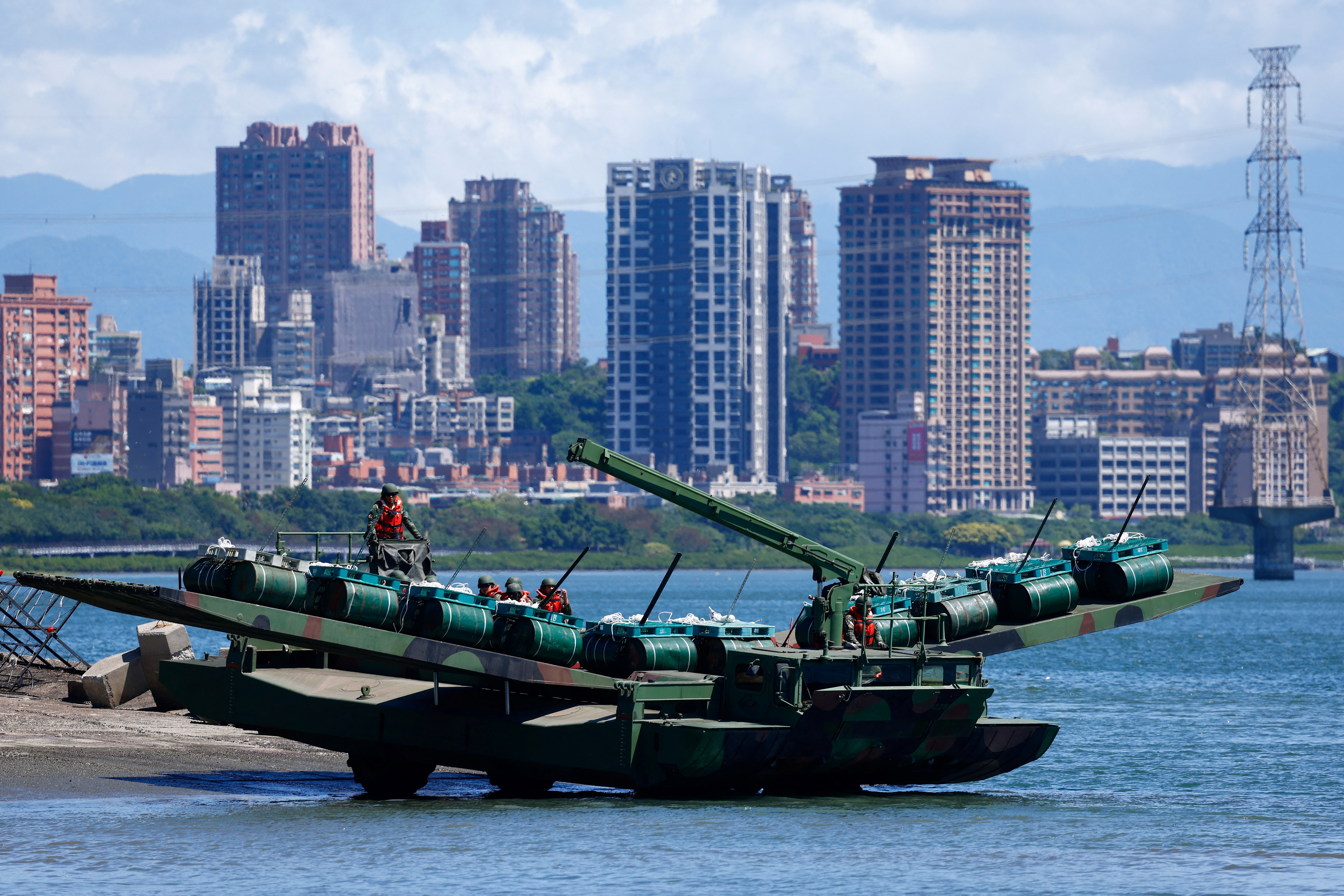 Soldiers practice laying mines and nets to stymie the landing of enemy forces at the mouth of a major river leading to the city in Taipei, Taiwan July 22, 2024. REUTERS/Ann Wang