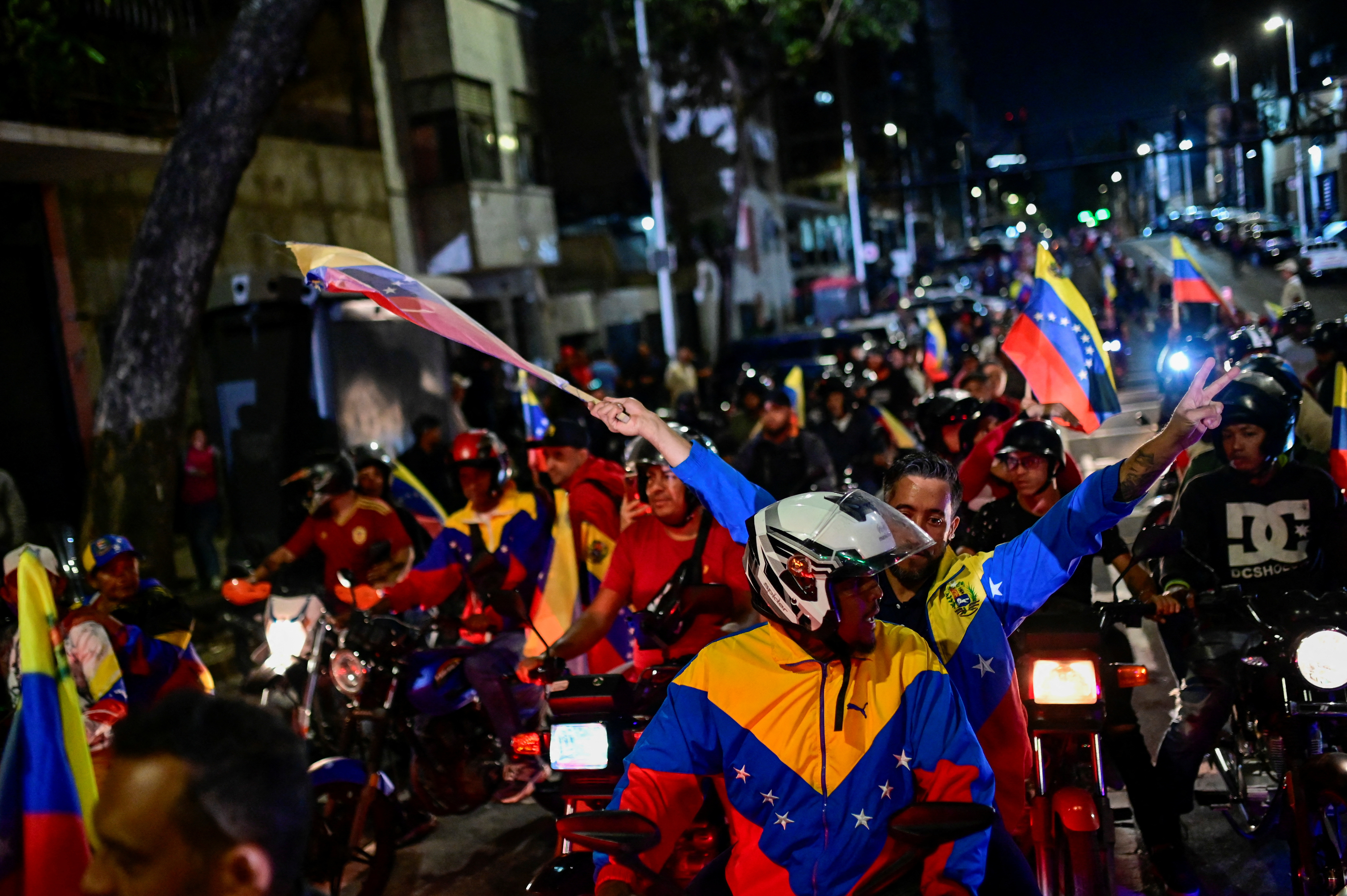 Supporters of Venezuela's President Nicolas Maduro celebrate after he won third term in the presidential election