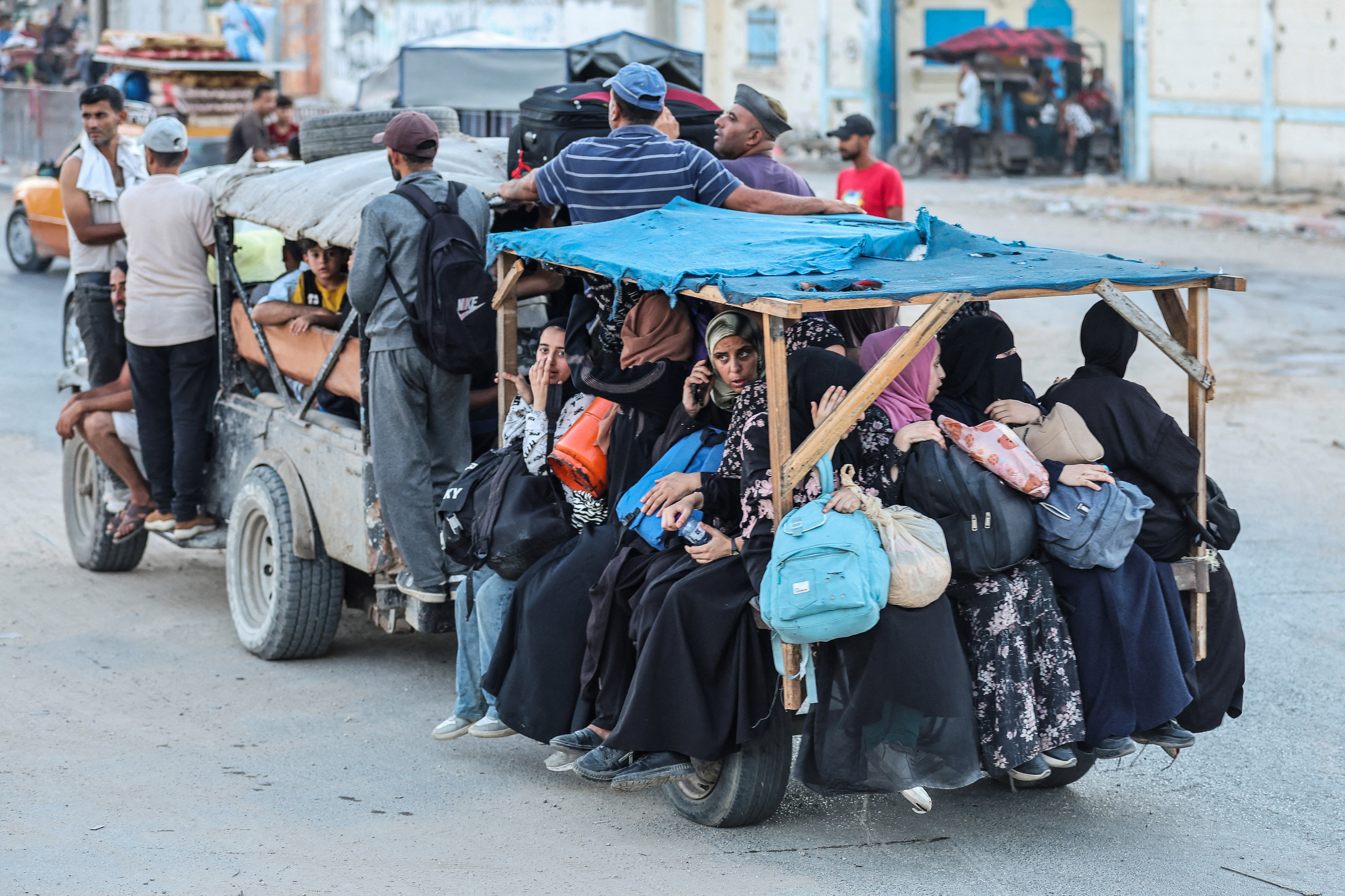 Palestinians make their way as they flee Bureij after they were ordered by Israeli army to evacuate the area