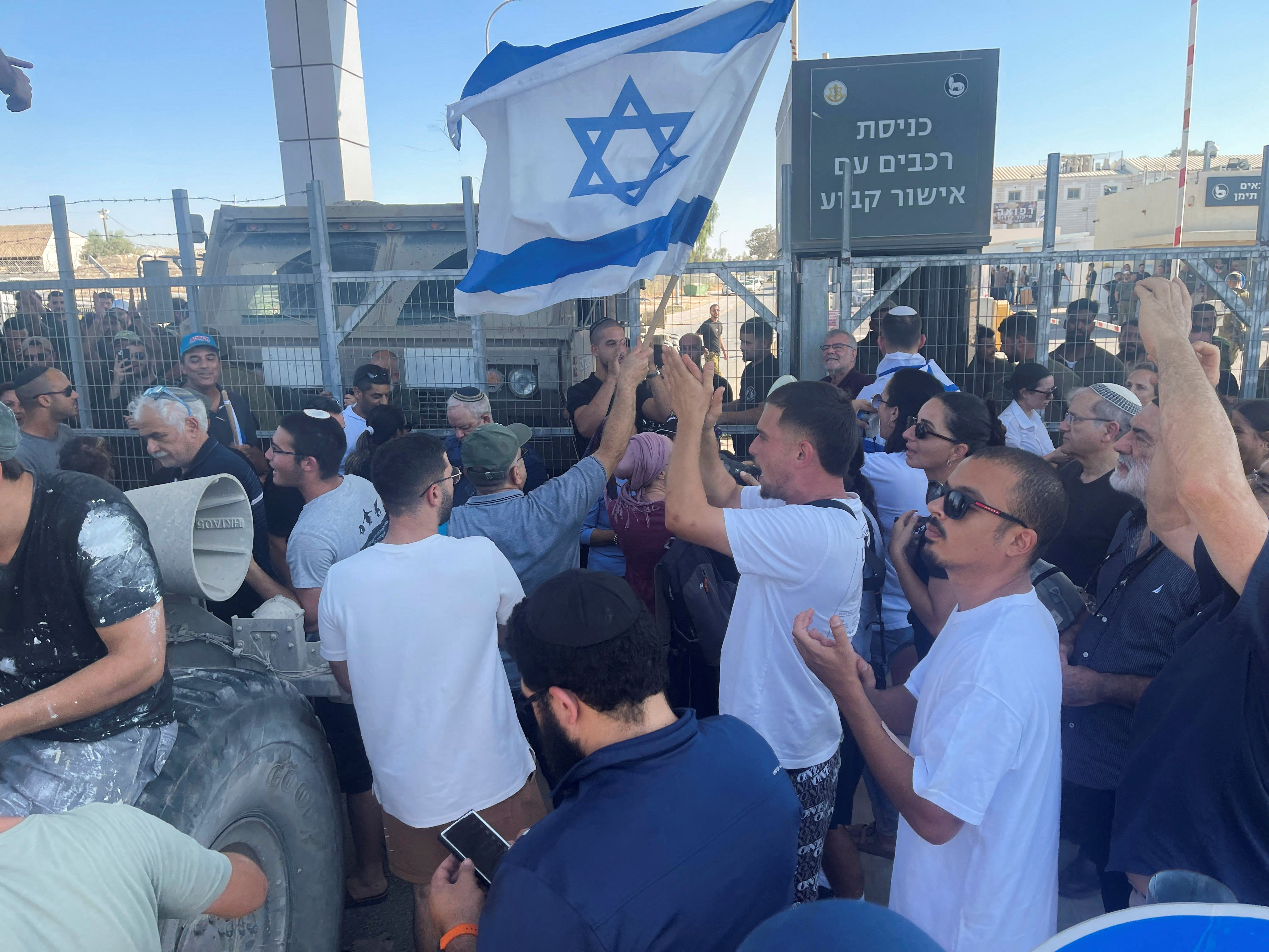 Right-wing protesters wave Israeli flags outside Sde Teiman detention facility