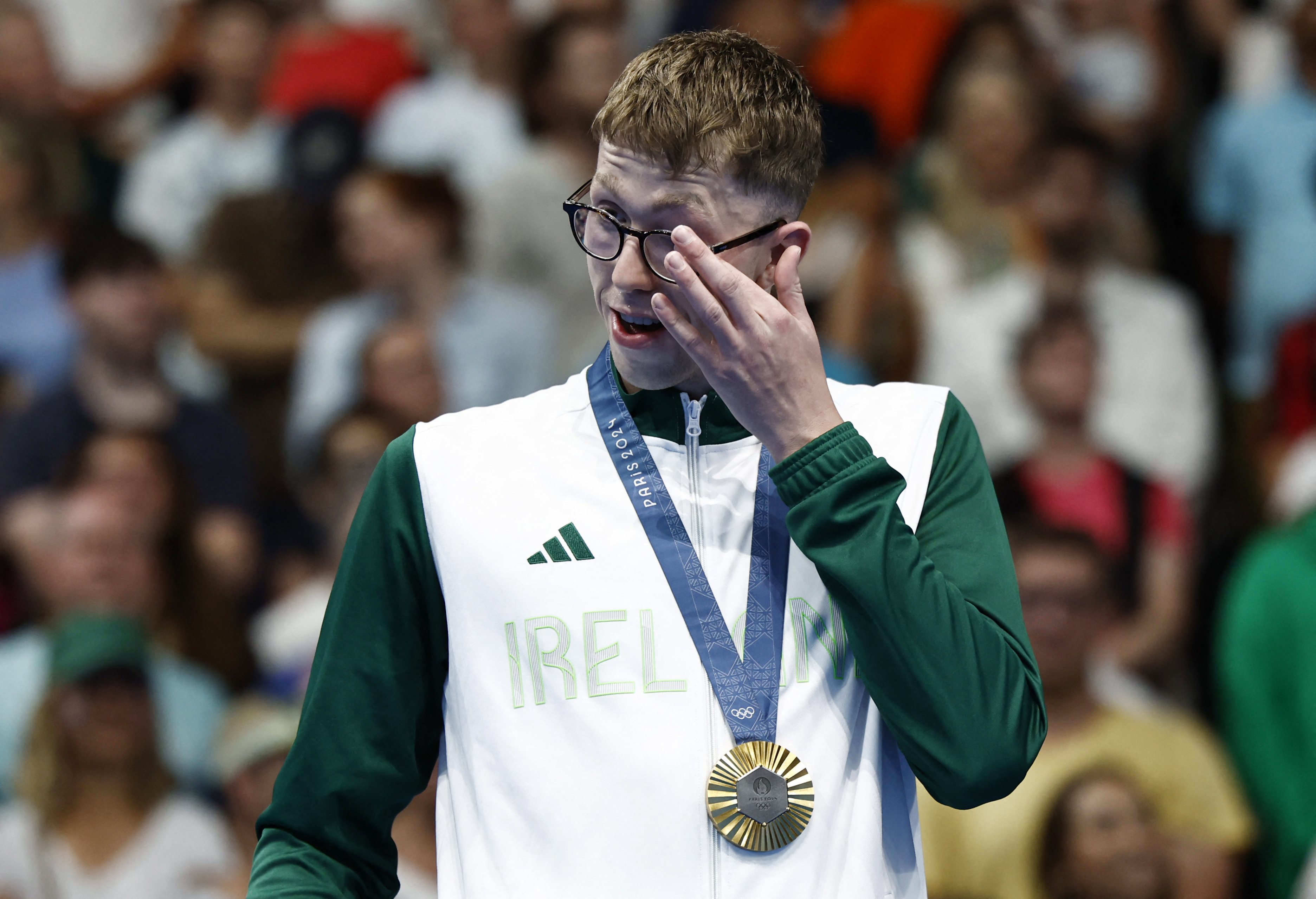 Paris 2024 Olympics - Swimming - Men's 800m Freestyle Victory Ceremony - Paris La Defense Arena, Nanterre, France - July 30, 2024. Gold medallist Daniel Wiffen of Ireland reacts as he celebrates after winning and establishing Olympic record. REUTERS/Clodagh Kilcoyne