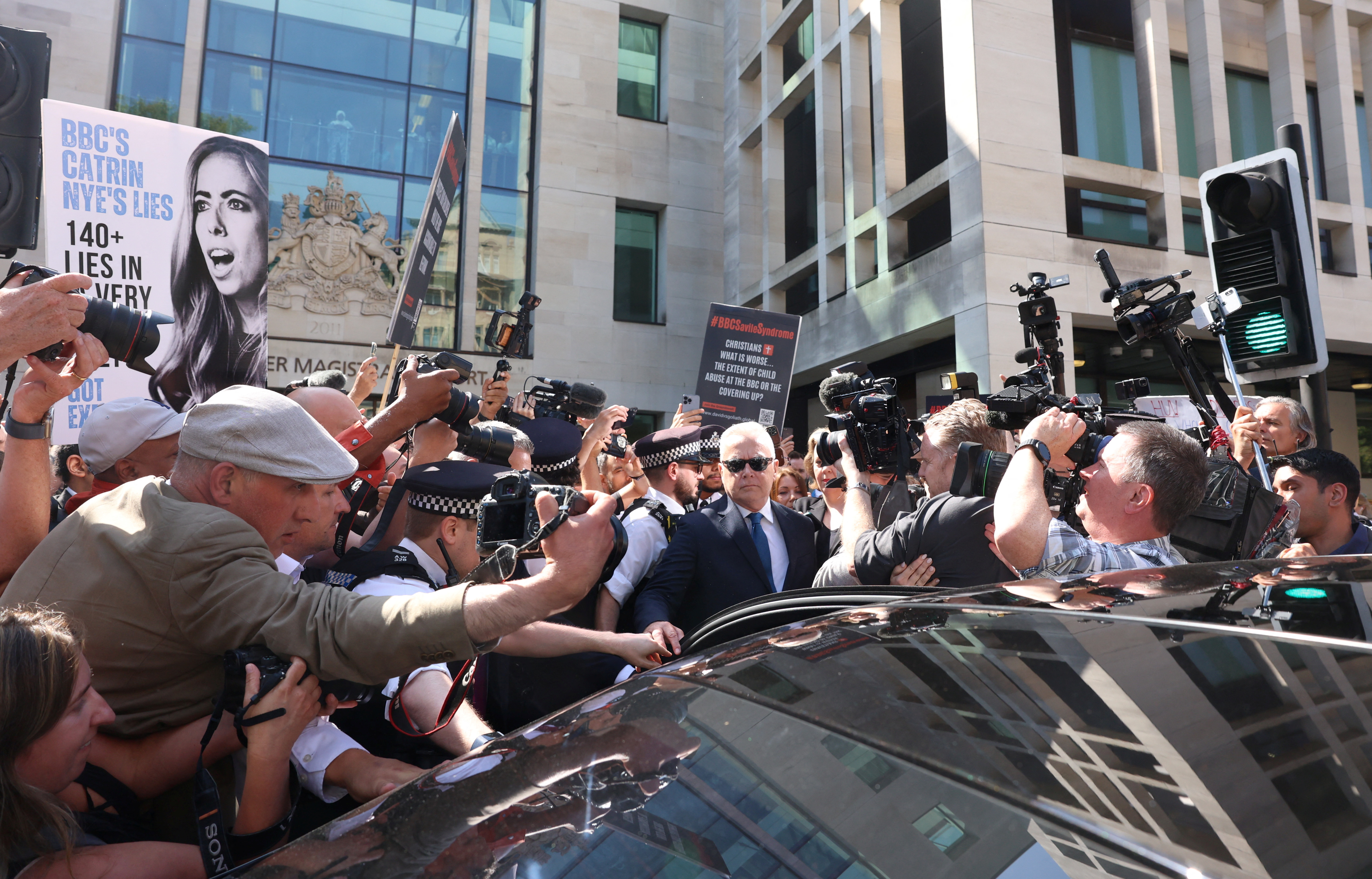 Former BBC news presenter Huw Edwards gets into a car outside Westminster Magistrates Court