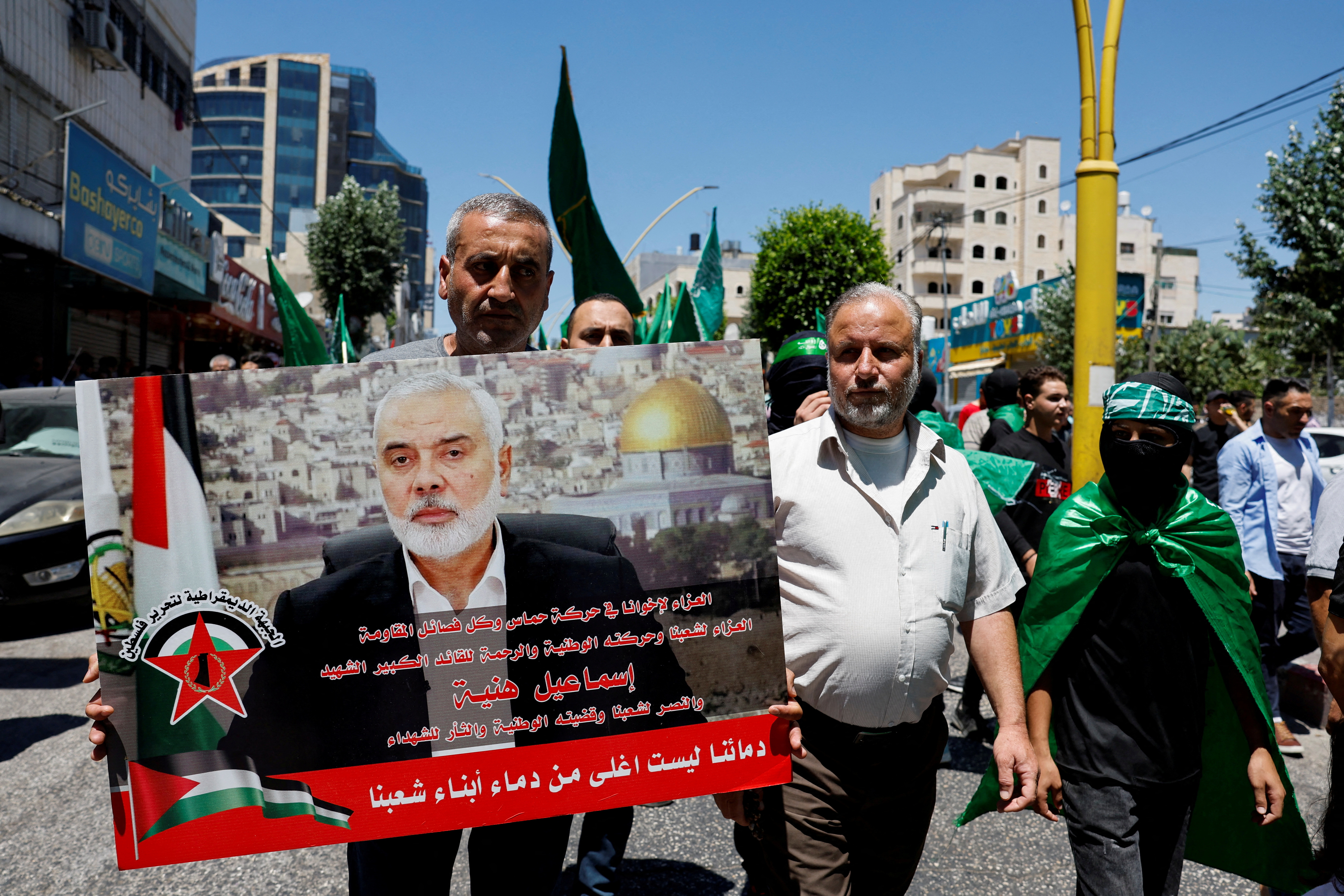 Palestinians attend a protest after the assassination of Hamas leader Ismail Haniyeh in Iran, in Hebron