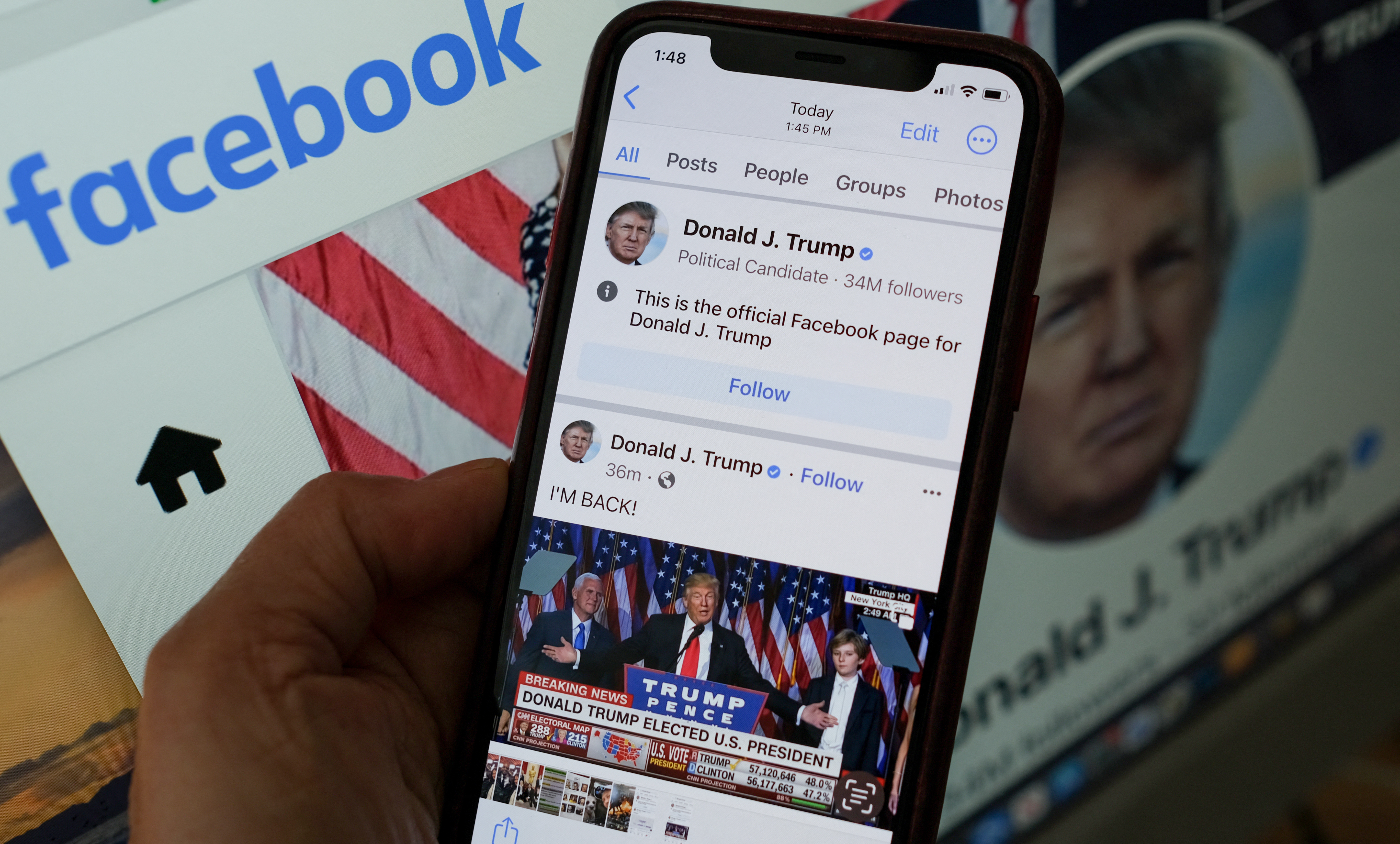 This illustration photo show the Facebook page of former President Donald Trump on a smartphone screen in Los Angeles, March 17, 2023. Former president Donald Trump wrote his first posts on his reinstated Facebook and YouTube accounts on March 17, 2023, more than two years after he was banned over the US Capitol insurrection. "I'M BACK," Trump said, alongside a 12-second video clip that appeared to show him giving his victory speech after winning the 2016 election, as he exclaimed: "Sorry to keep you waiting -- complicated business." (Photo by Chris DELMAS / AFP)
