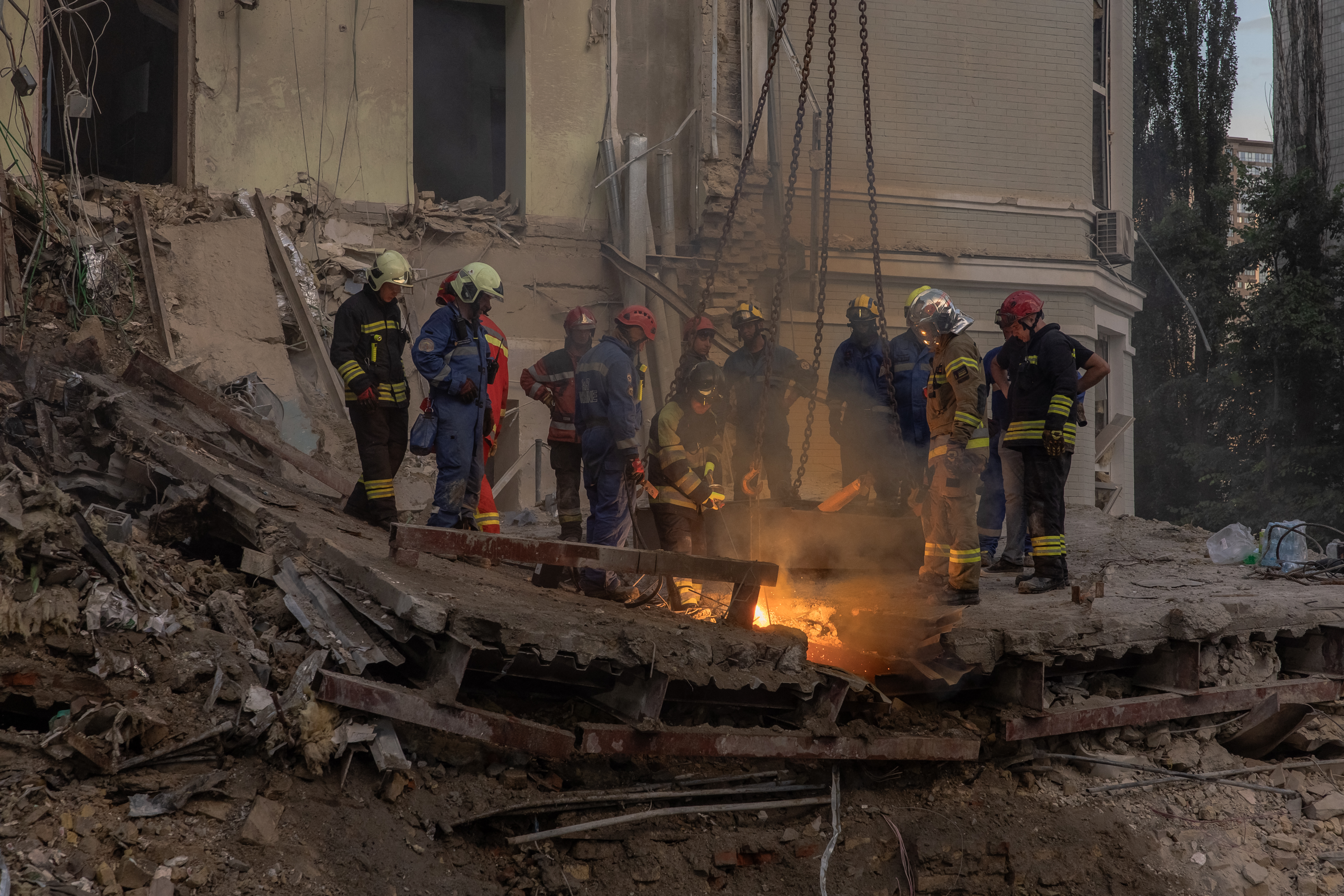 Emergency and rescue personnel operate and clear the rubble of the destroyed building of Ohmatdyt Children's Hospital following a missile strike in the Ukrainian capital of Kyiv on July 8, 2024, amid the Russian invasion of Ukraine. - Russia struck cities across Ukraine on July 8, 2024, with a missile barrage that killed three dozen people and ripped open a children's hospital in Kyiv, an assault condemned as a ruthless attack on civilians. (Photo by Roman PILIPEY / AFP)