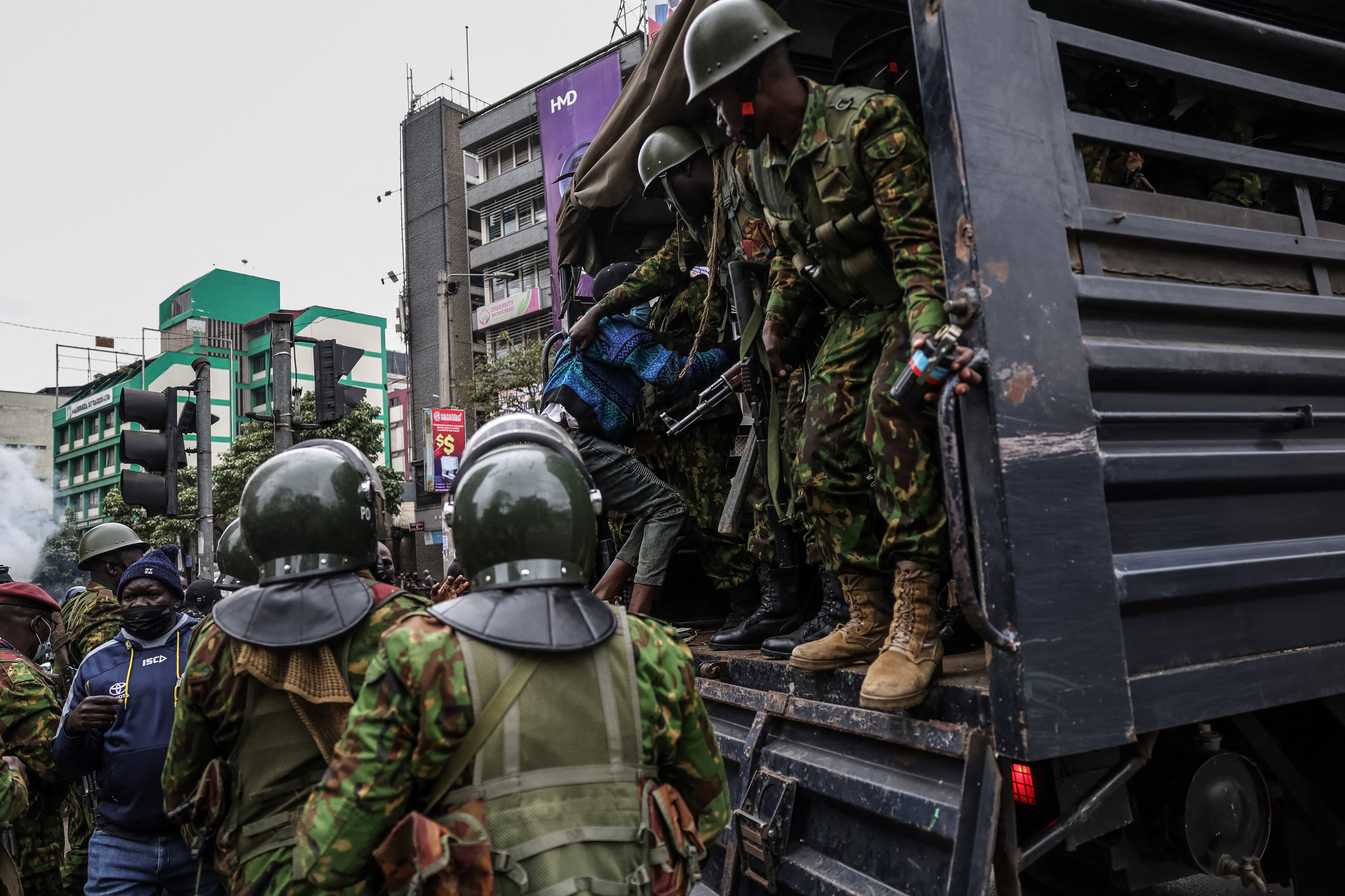 A detained protester is loaded into a Kenyan riot police truck during renewed demonstrations in Nairobi on July 16, 2024. - Police were out in force in the centre of Kenya's capital on Tuesday after calls for more demonstrations against the embattled government of President William Ruto. Activists led by young Gen-Z Kenyans launched peaceful rallies a month ago against deeply unpopular tax hikes but they descended into deadly violence last month, prompting Ruto to drop the planned increases. (Photo by Tony Karumba / AFP)