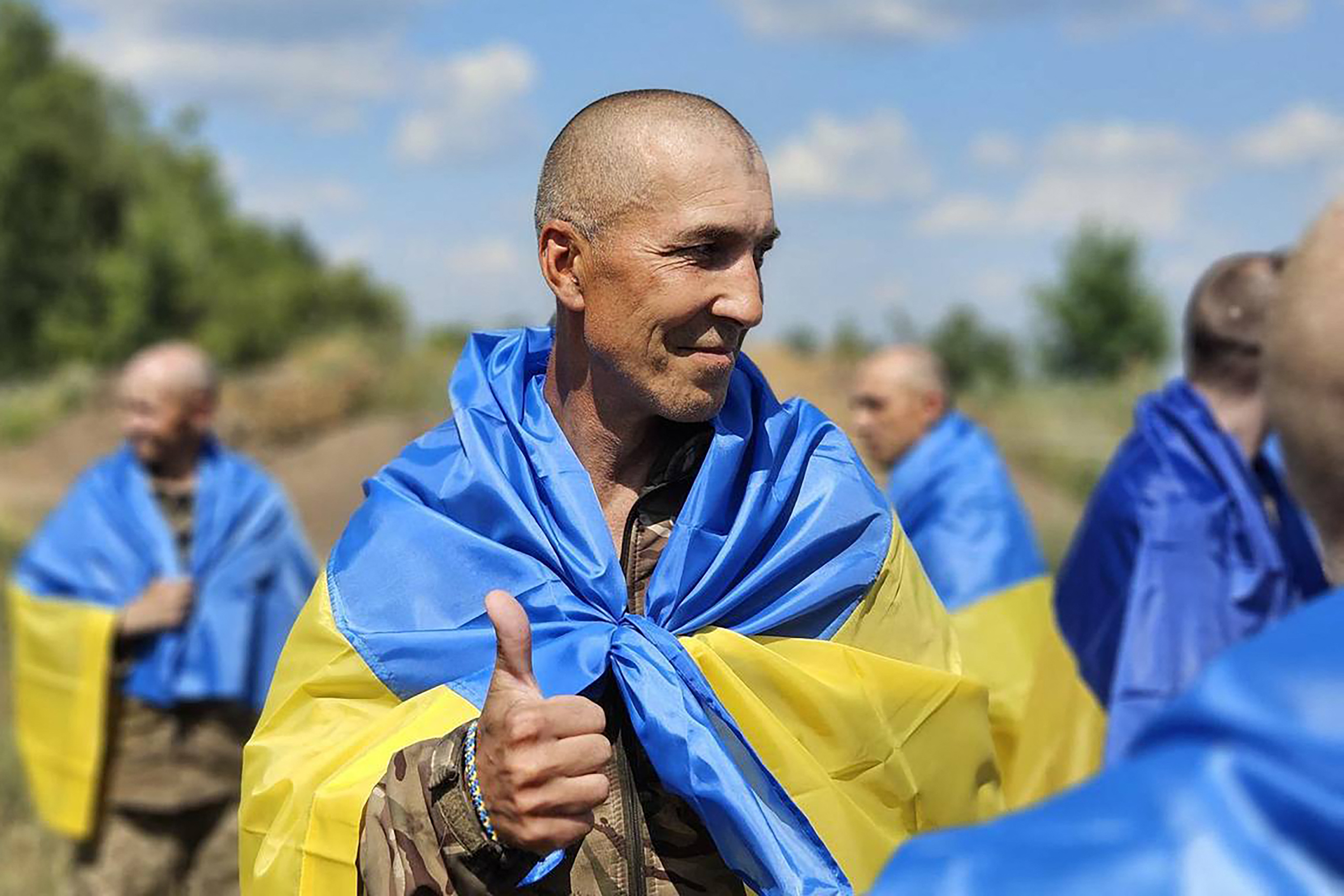 In this handout photograph released by Ukrainian presidential press service on July 17, 2024, a Ukrainian prisoner of war (POW) gestures following a swap at an undisclosed location in Ukraine.