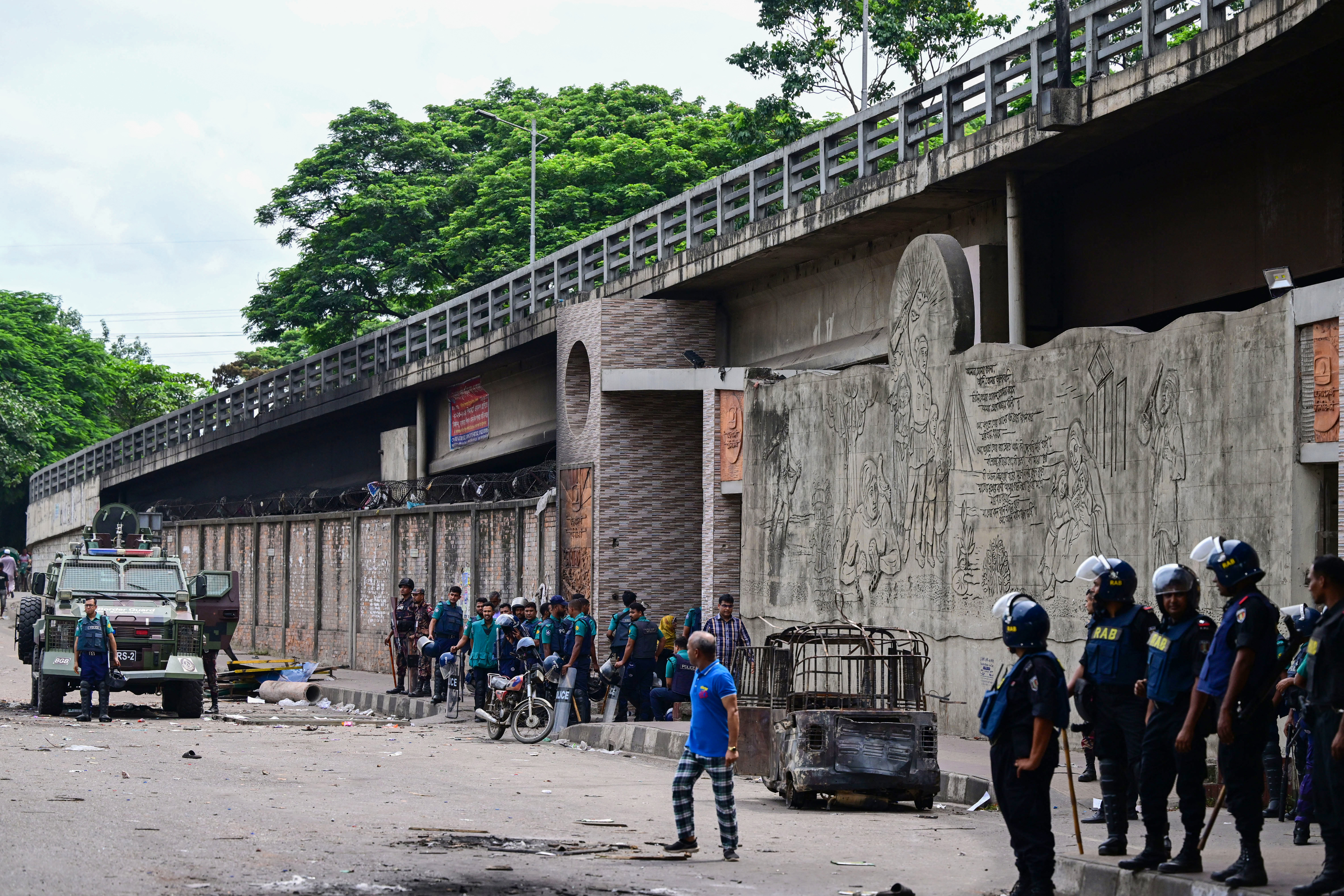 Police stand guard at the headquarters of state broadcaster Bangladesh Television