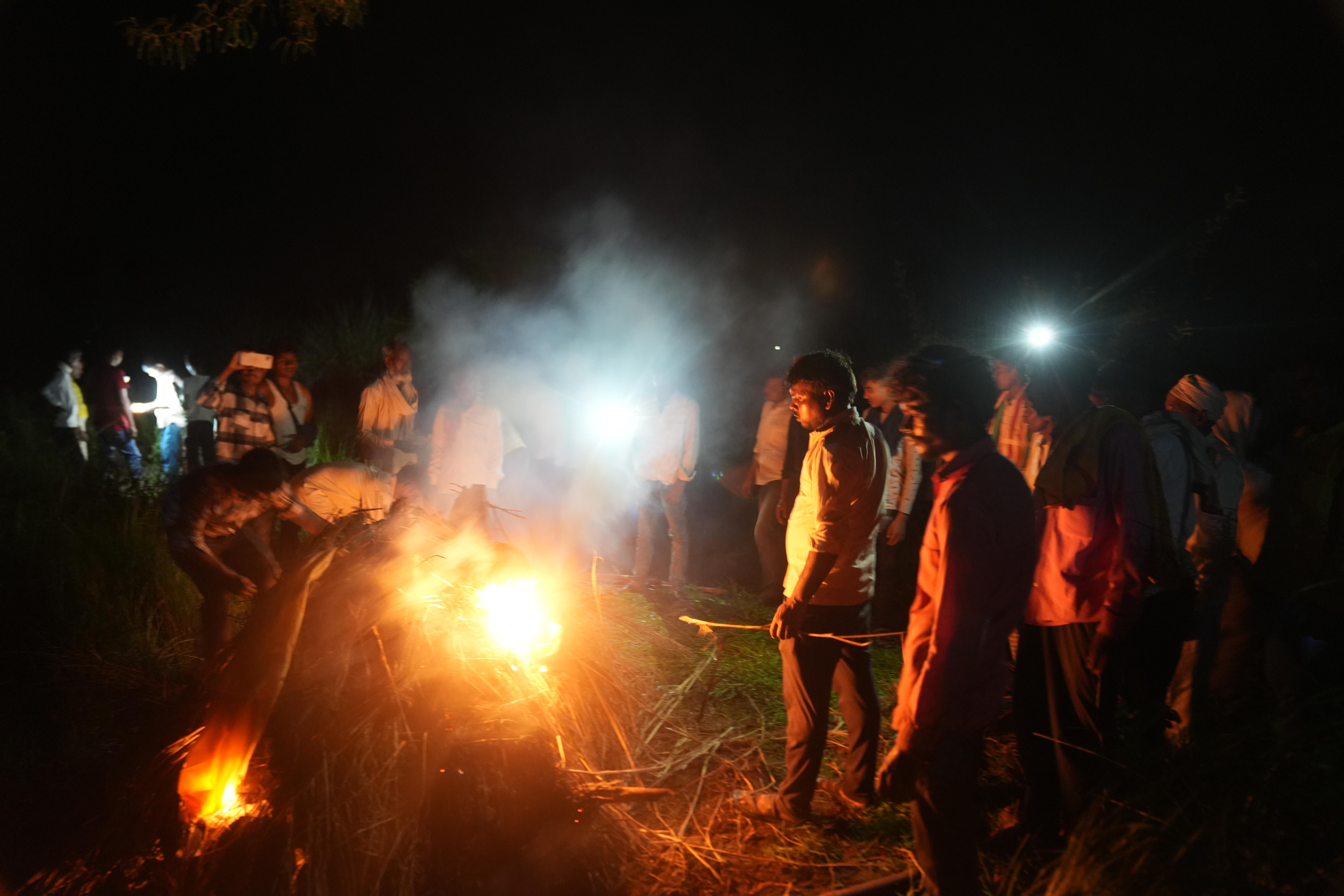 Lal Ram Singh is cremating his wife Kamlesh Devi, 22, and daughter Chanchal, 7 months old, who died in a stampede in Hathras district, Uttar Pradesh