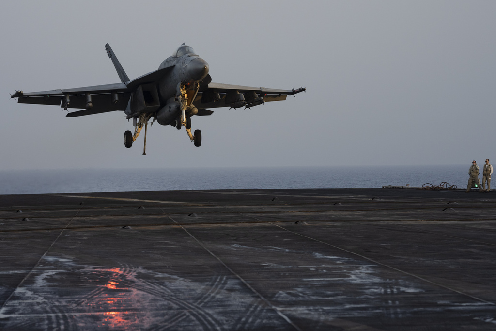 A fighter jet lands on the USS Dwight D. Eisenhower in the Red Sea on Tuesday, June 11, 2024. The USS Dwight D. Eisenhower may be one of the oldest aircraft carriers in the U.S. Navy, but it's still fighting — despite repeated false claims by Yemen's Houthi rebels. (AP Photo/Bernat Armangue)