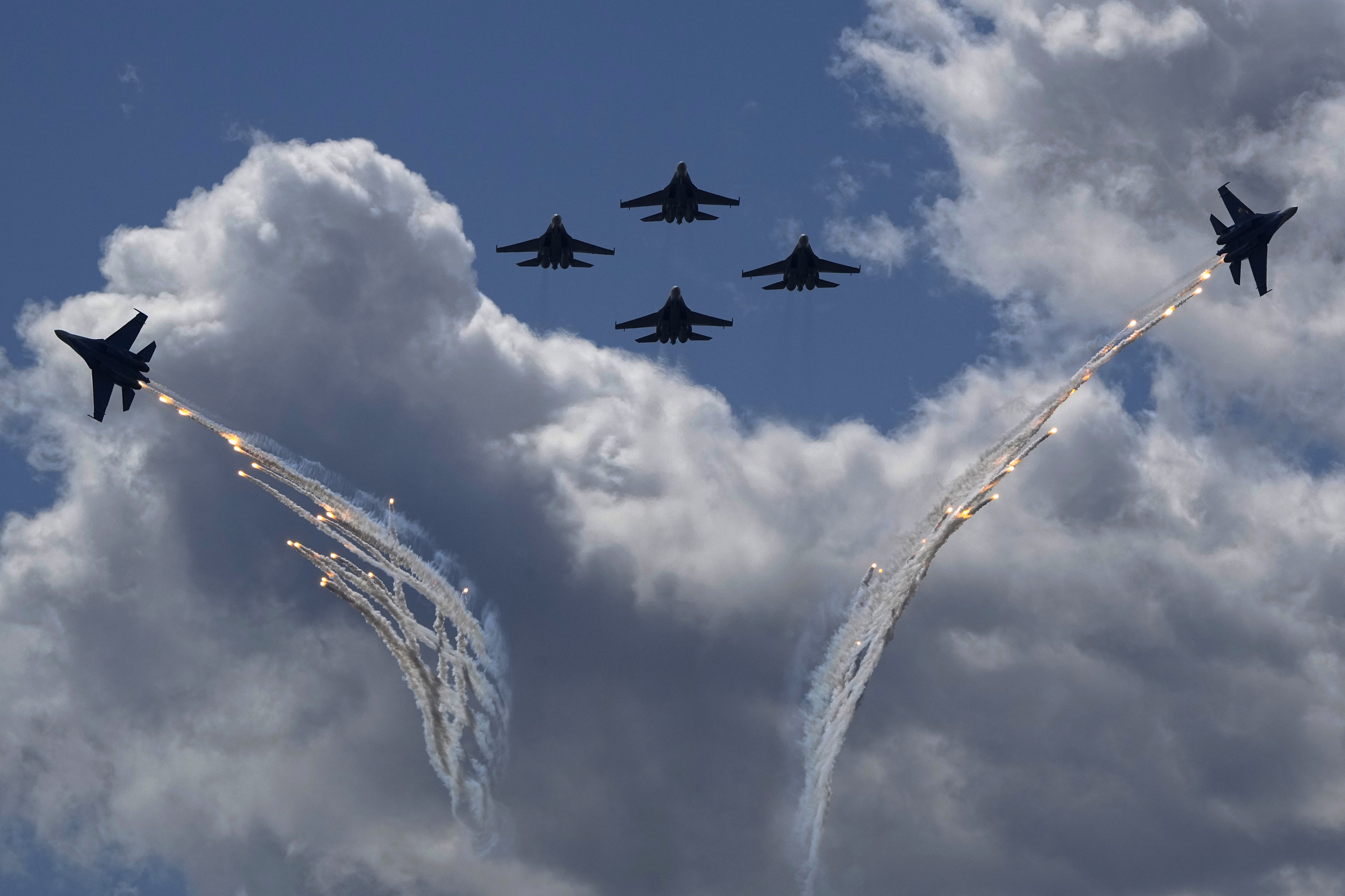 Sukhoi Su-35S jet fighters of the Russian Knights aerobatic team perform during the International Maritime Defence Show 'Fleet-2024' in Kronstadt, outside St. Petersburg, Russia, Friday, June 21, 2024. (AP Photo/Dmitri Lovetsky)