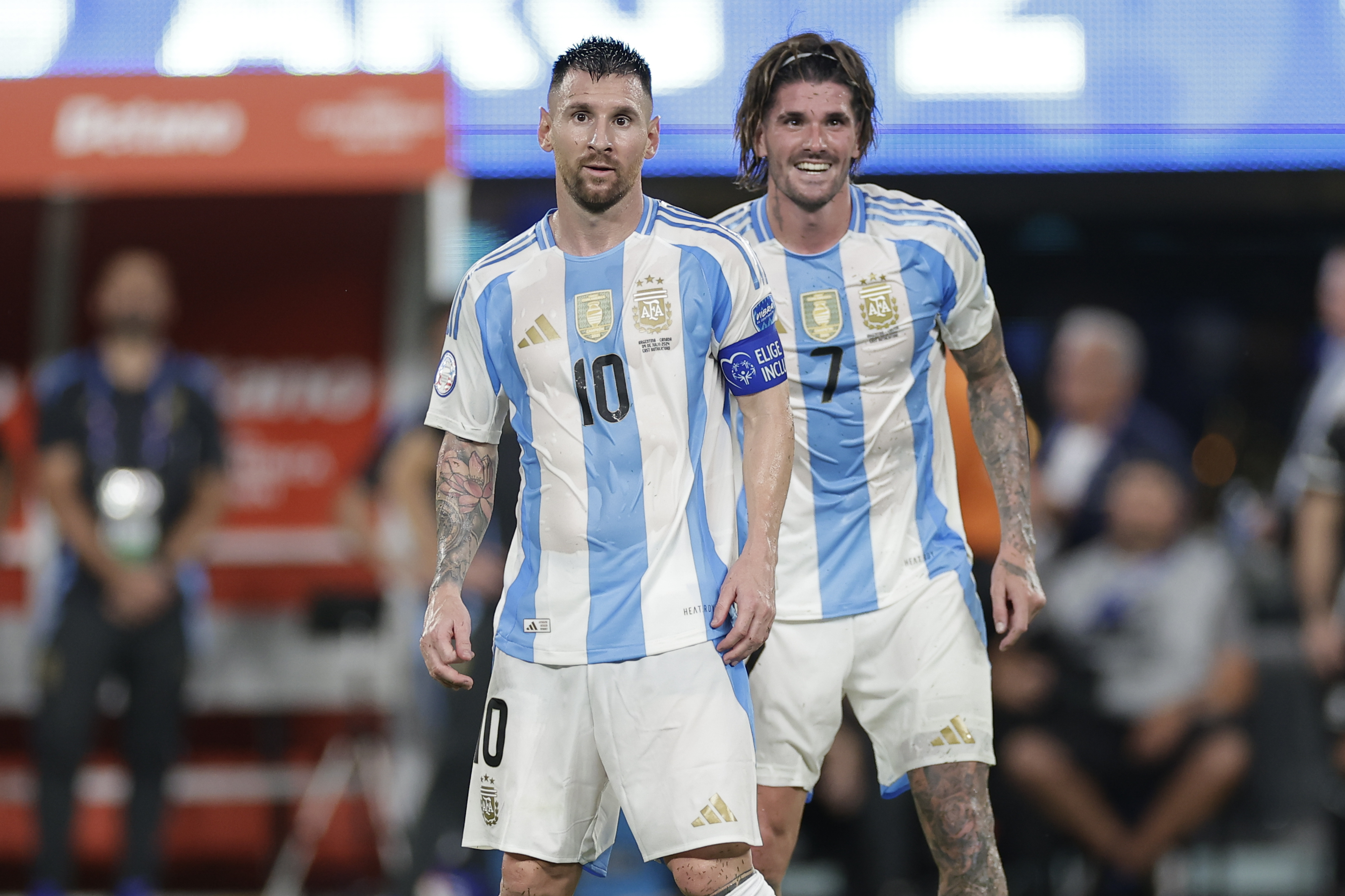 Argentina's Lionel Messi, left, and Rodrigo De Paul stand on the pitch during a Copa America semifinal soccer match against Canada in East Rutherford, N.J., Tuesday, July 9, 2024. (AP Photo/Adam Hunger)