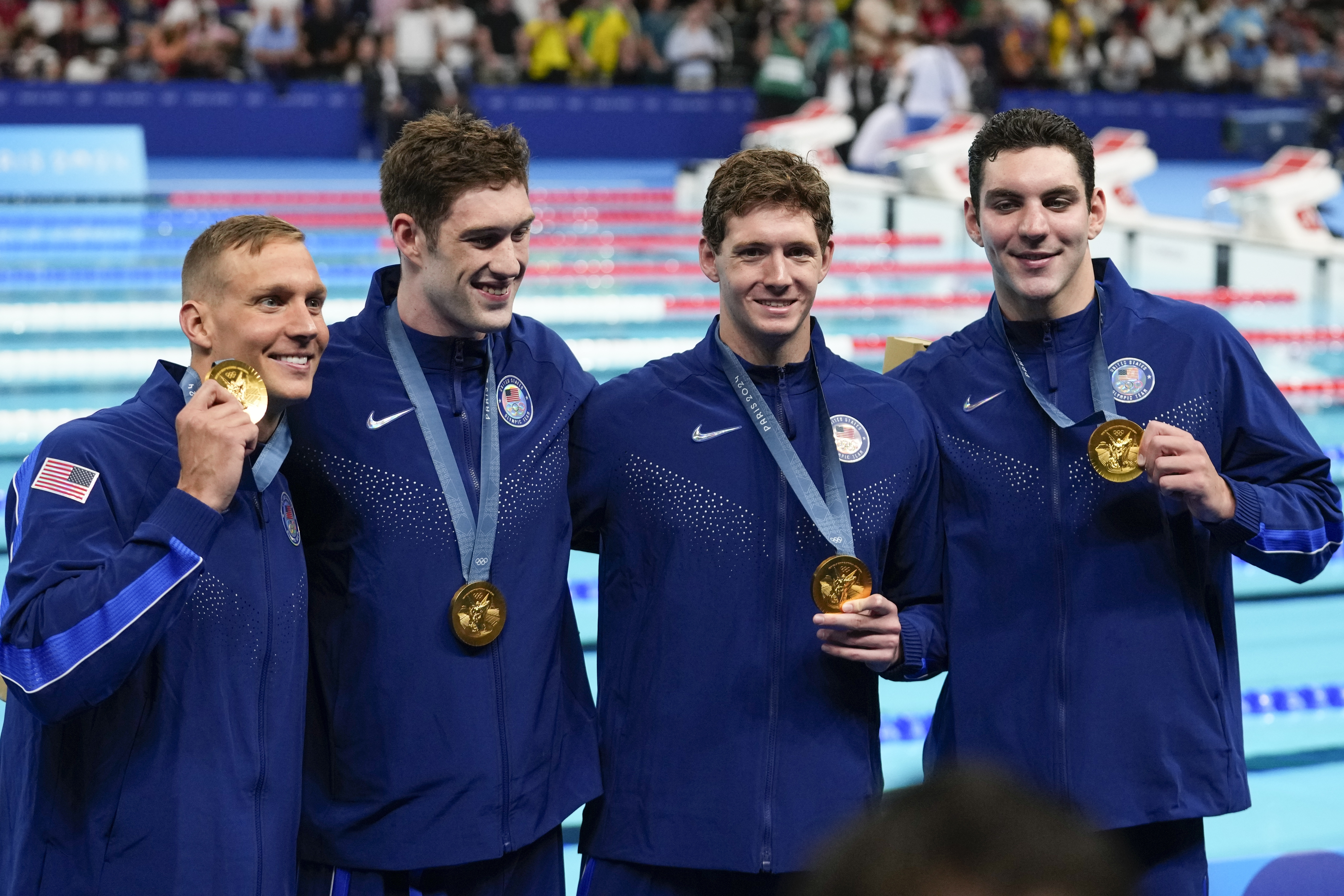 The United States men's 4x100-meter freestyle relay team celebrate after winning the gold medal at the 2024 Summer Olympics, Saturday, July 27, 2024, in Nanterre, France. (AP Photo/Petr David Josek)