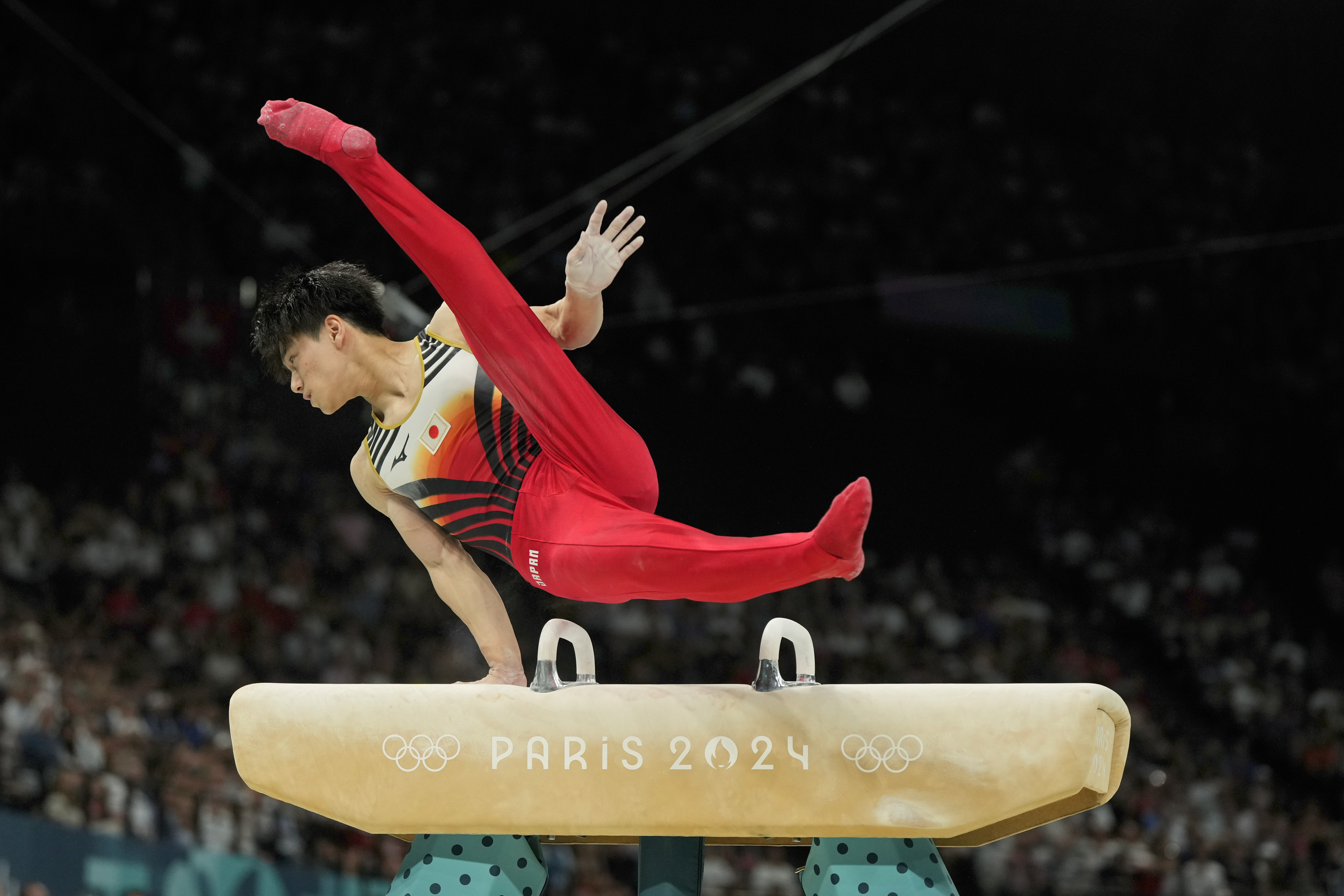 Daiki Hashimoto, of Japan, pommel during the men's artistic gymnastics team finals round at Bercy Arena at the 2024 Summer Olympics, Monday, July 29, 2024, in Paris, France. (AP Photo/Charlie Riedel)