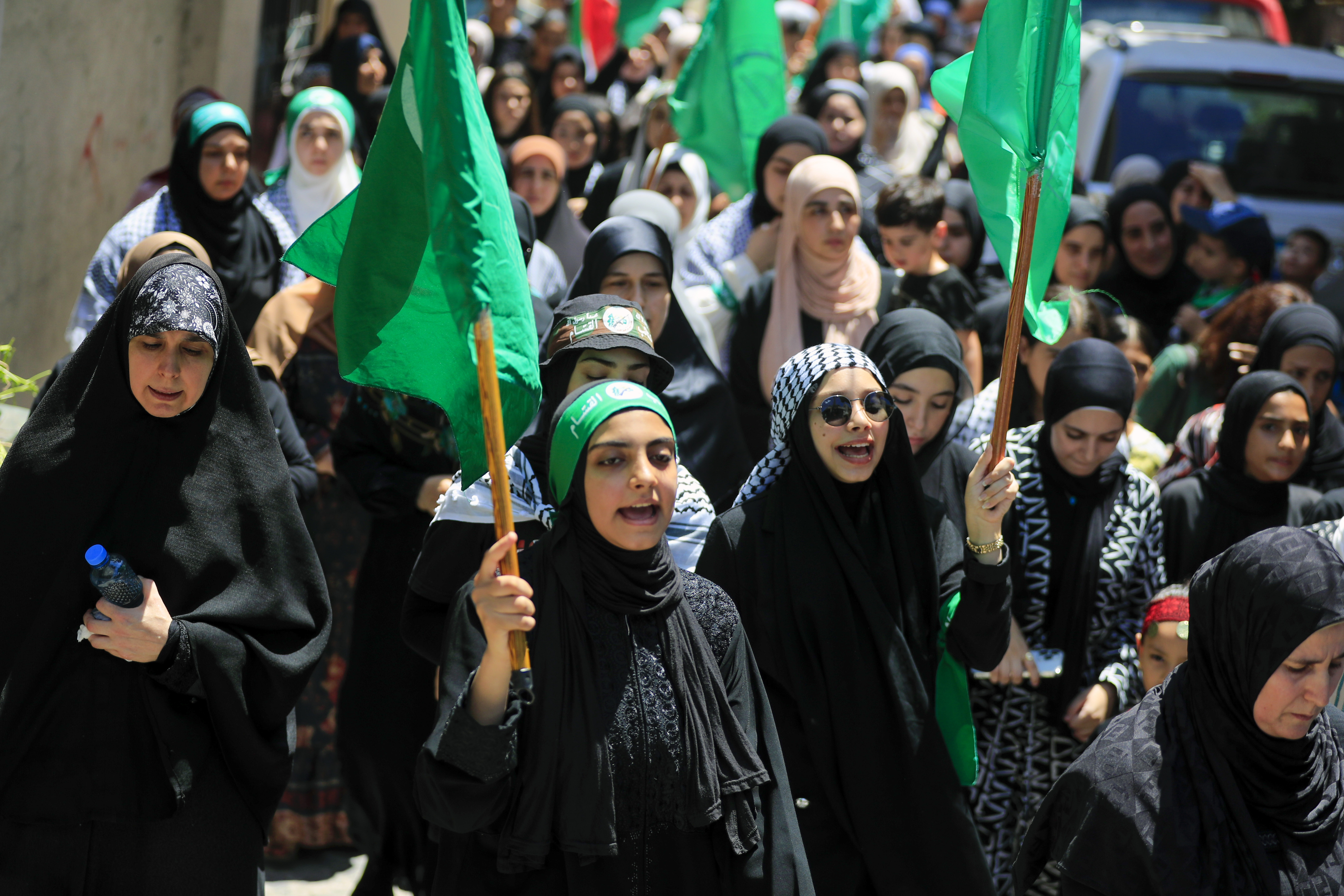 Hamas members chant slogans during a protest to condemn the killing of Hamas political chief Ismail Haniyeh, at al-Bass Palestinian refugee camp, in the southern port city of Tyre, Lebanon