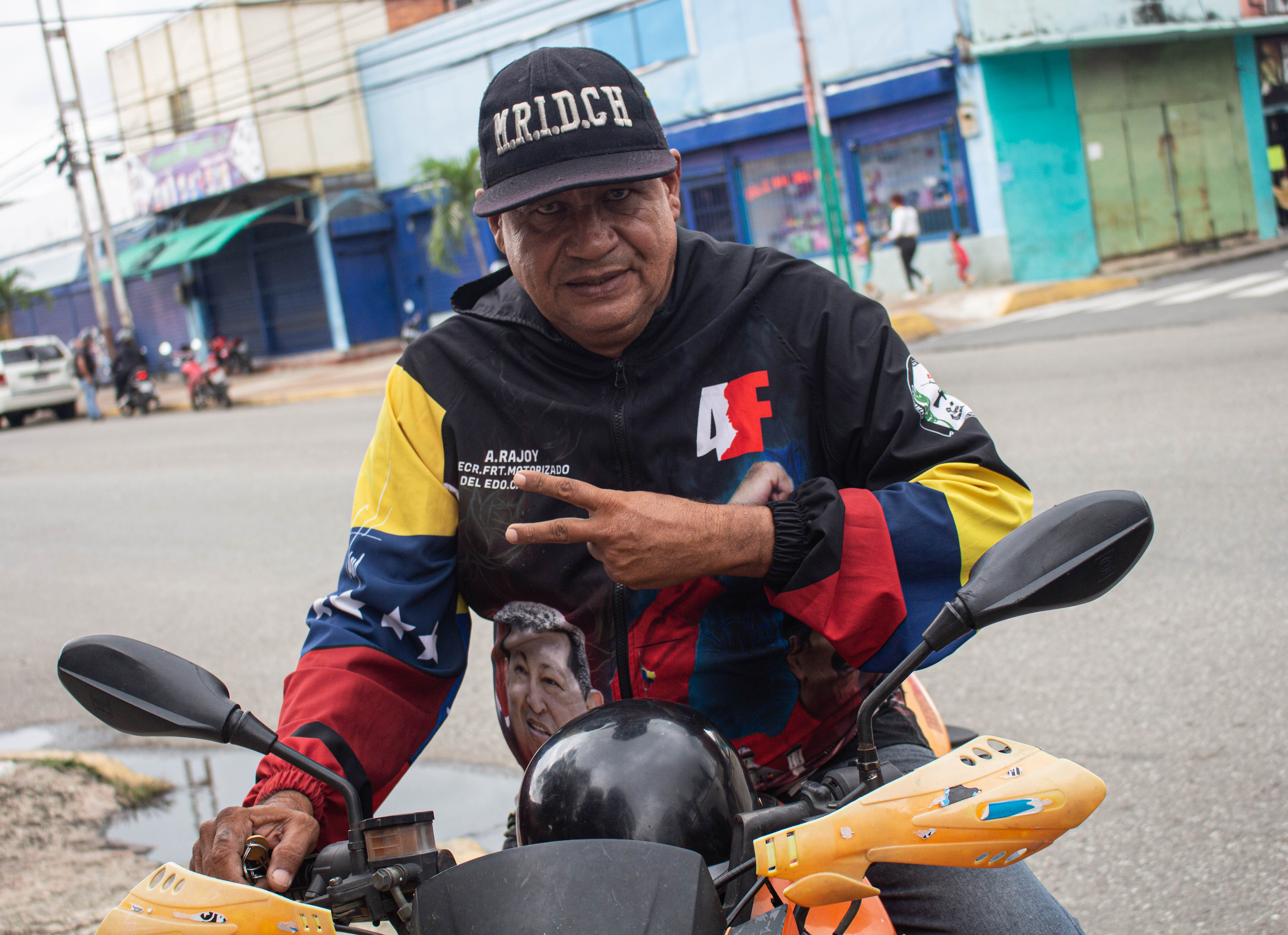 Alfredo Rojas wears a windbreaker jacket showing off his support for the late Hugo Chavez and Nicolas Maduro