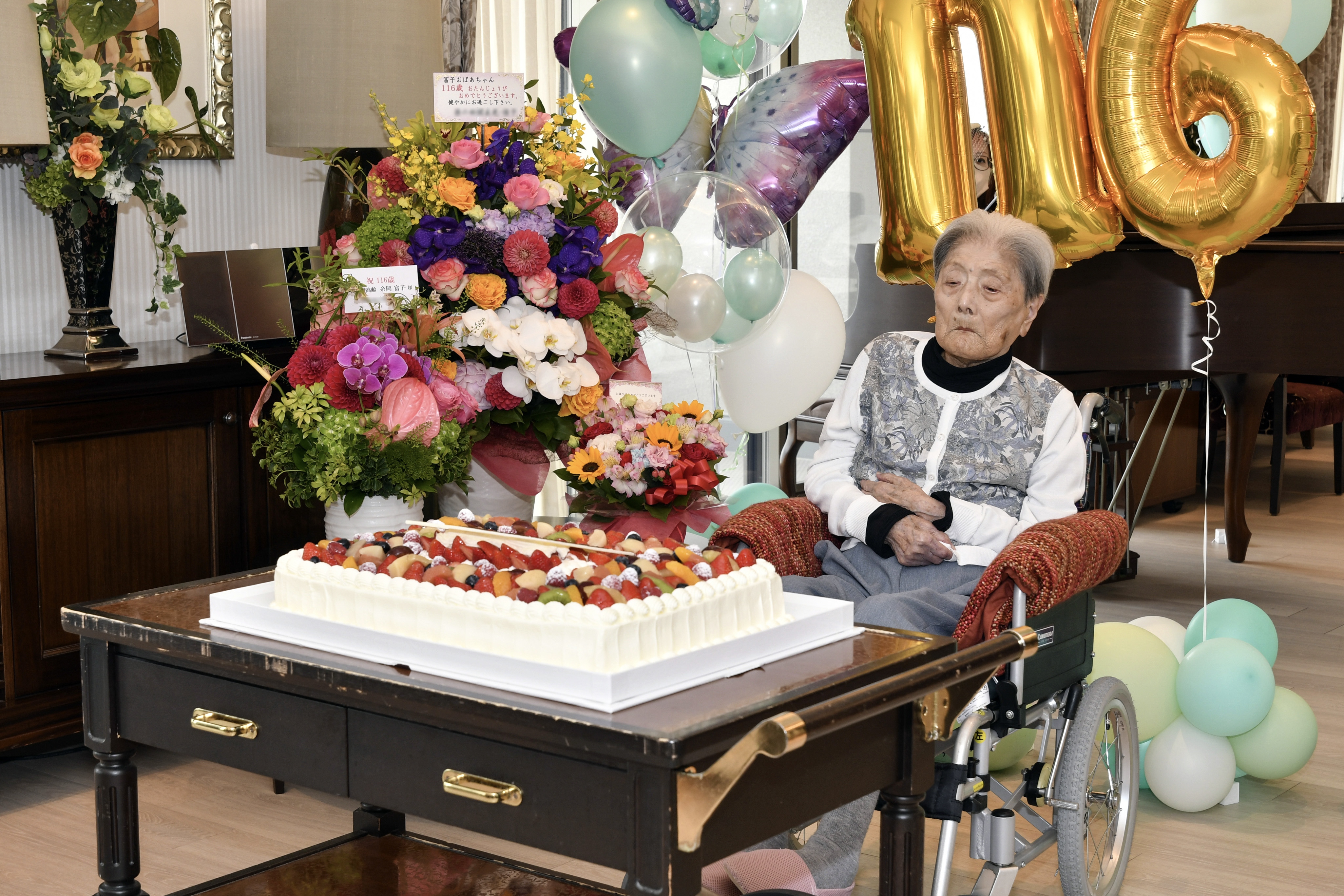 A handout photo taken by Ashiya City and made available via Jiji Press shows Tomiko Itooka celebrating her 116th birthday in Ashiya, Hyogo Prefecture, Japan