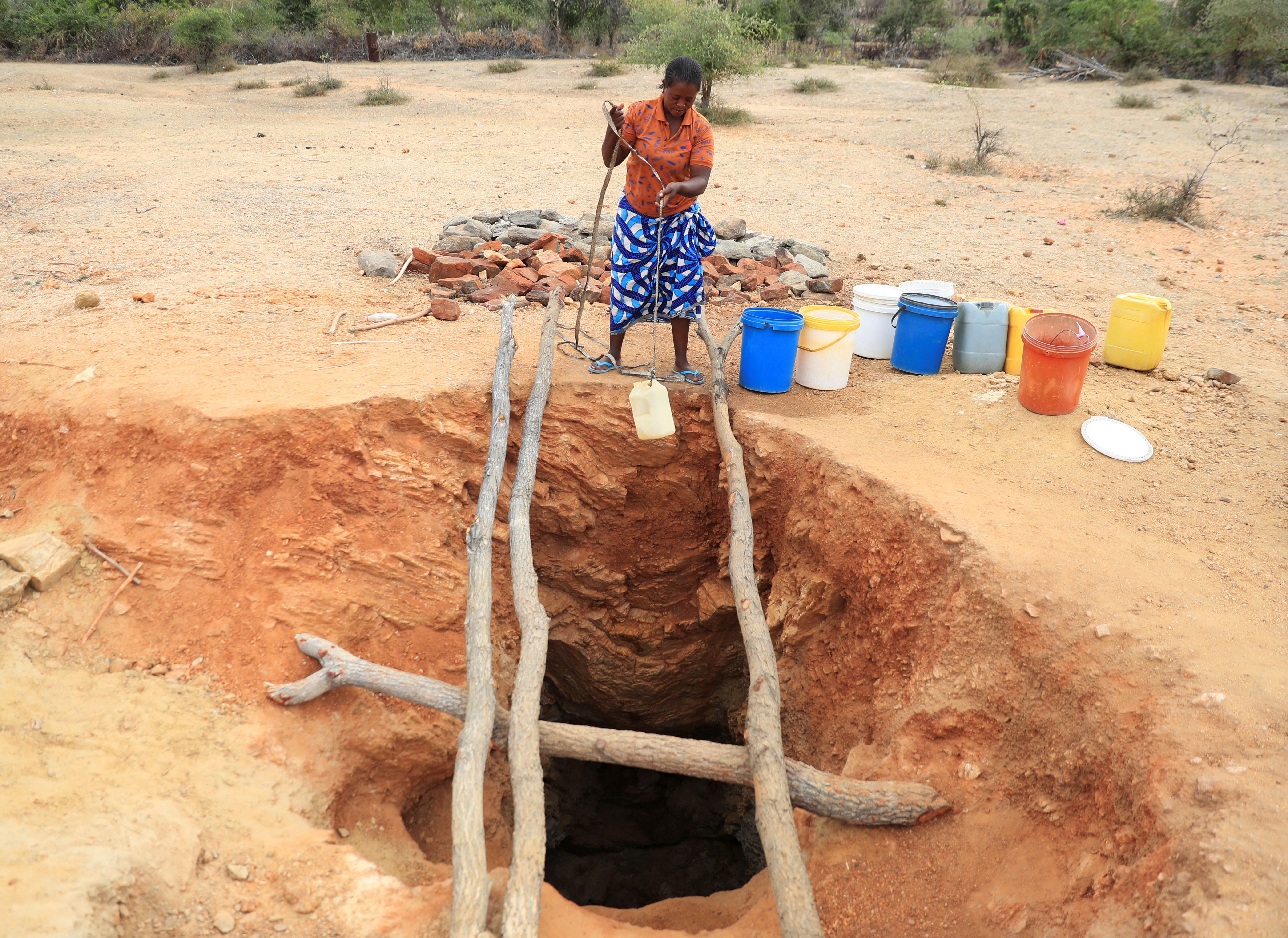 A woman fetches drinking water amid drought in southern Africa