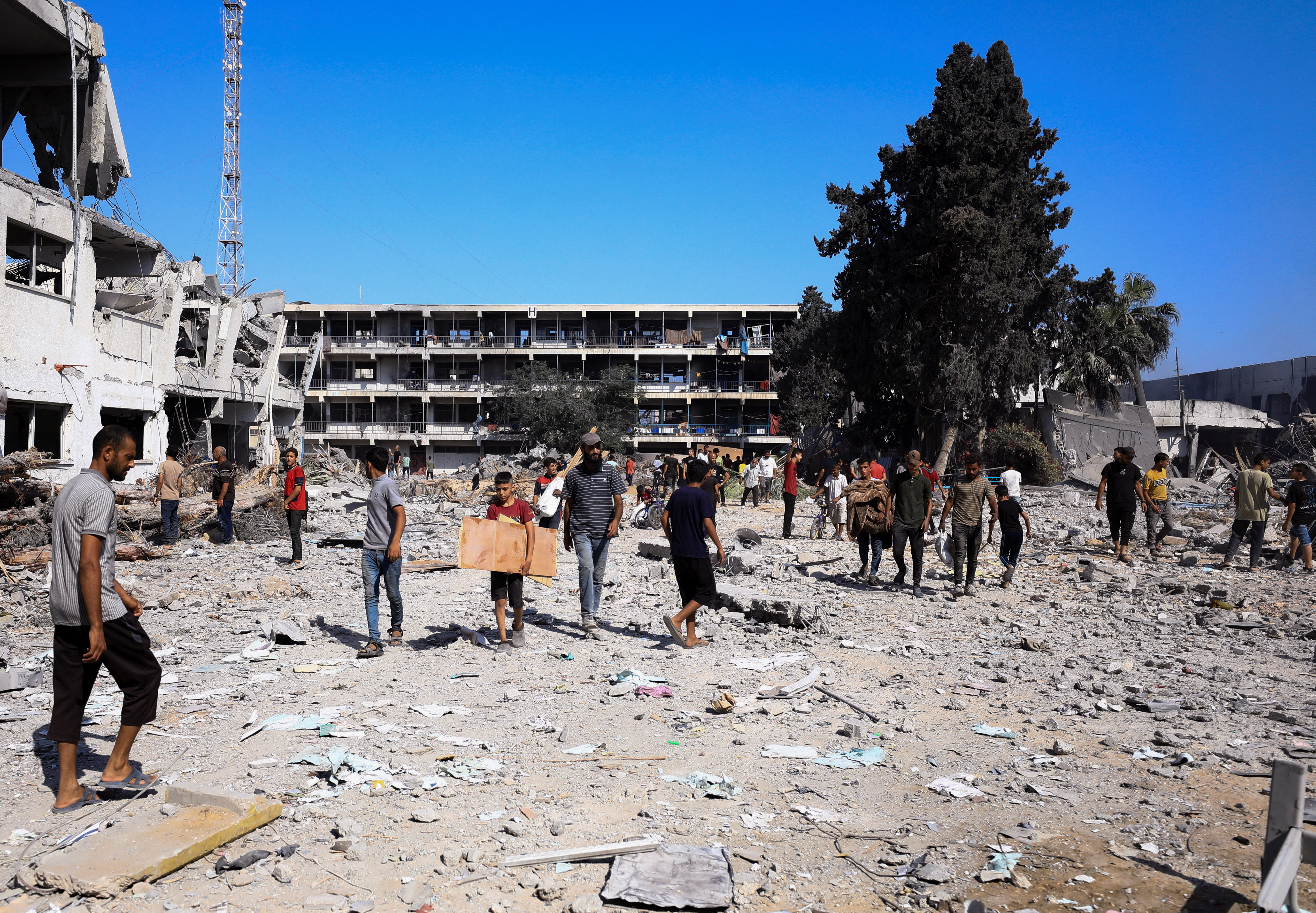 Palestinians gather to inspect the damages at the headquarters of UNRWA, following an Israeli raid, amid the Israel-Hamas conflict, in Gaza City, July 12, 2024. REUTERS/Dawoud Abu Alkas