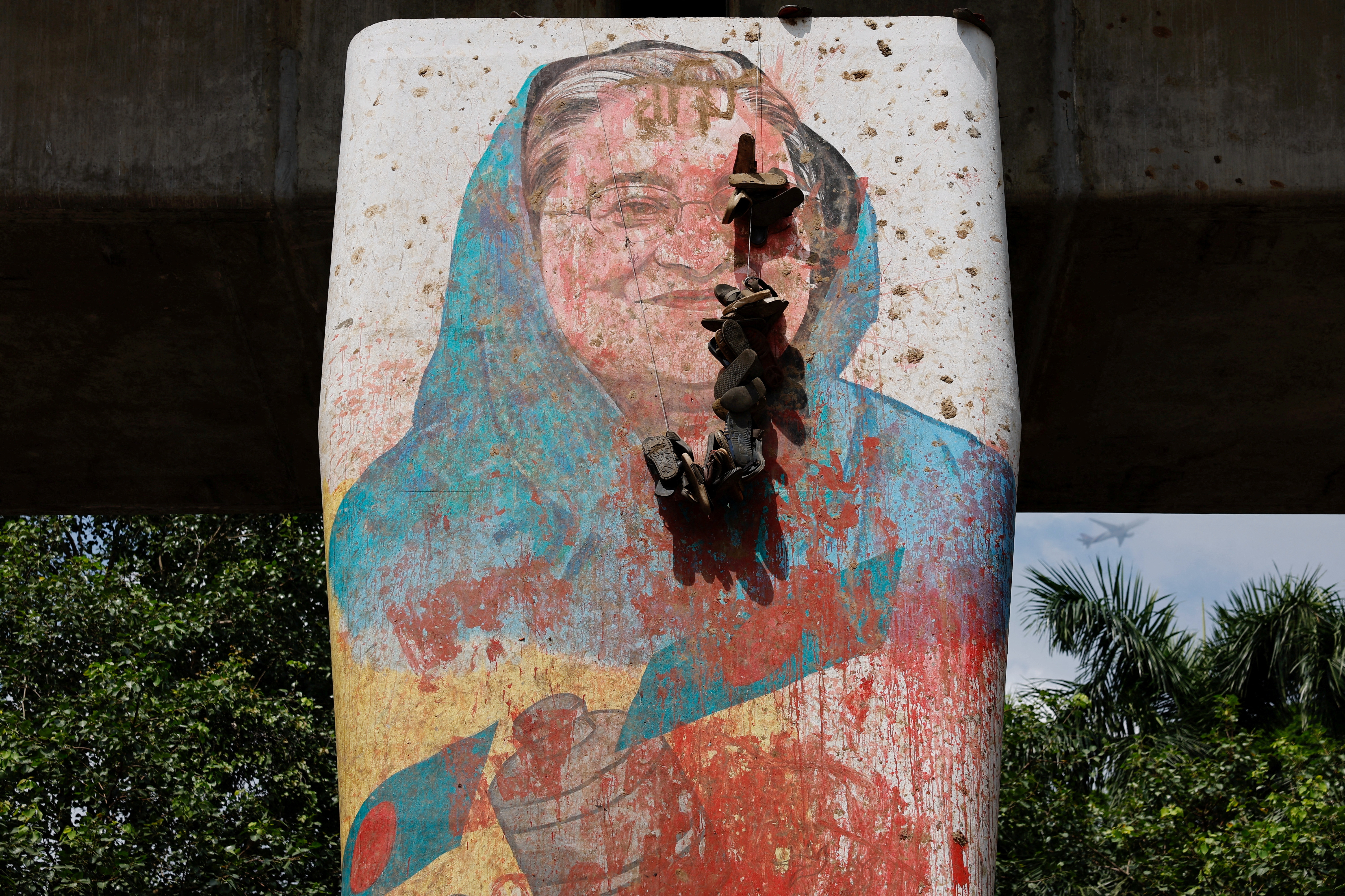 A view shows a mural of Bangladeshi Prime Minister Sheikh Hasina vandalised by protesters, a day after her resignation, in Dhaka, Bangladesh