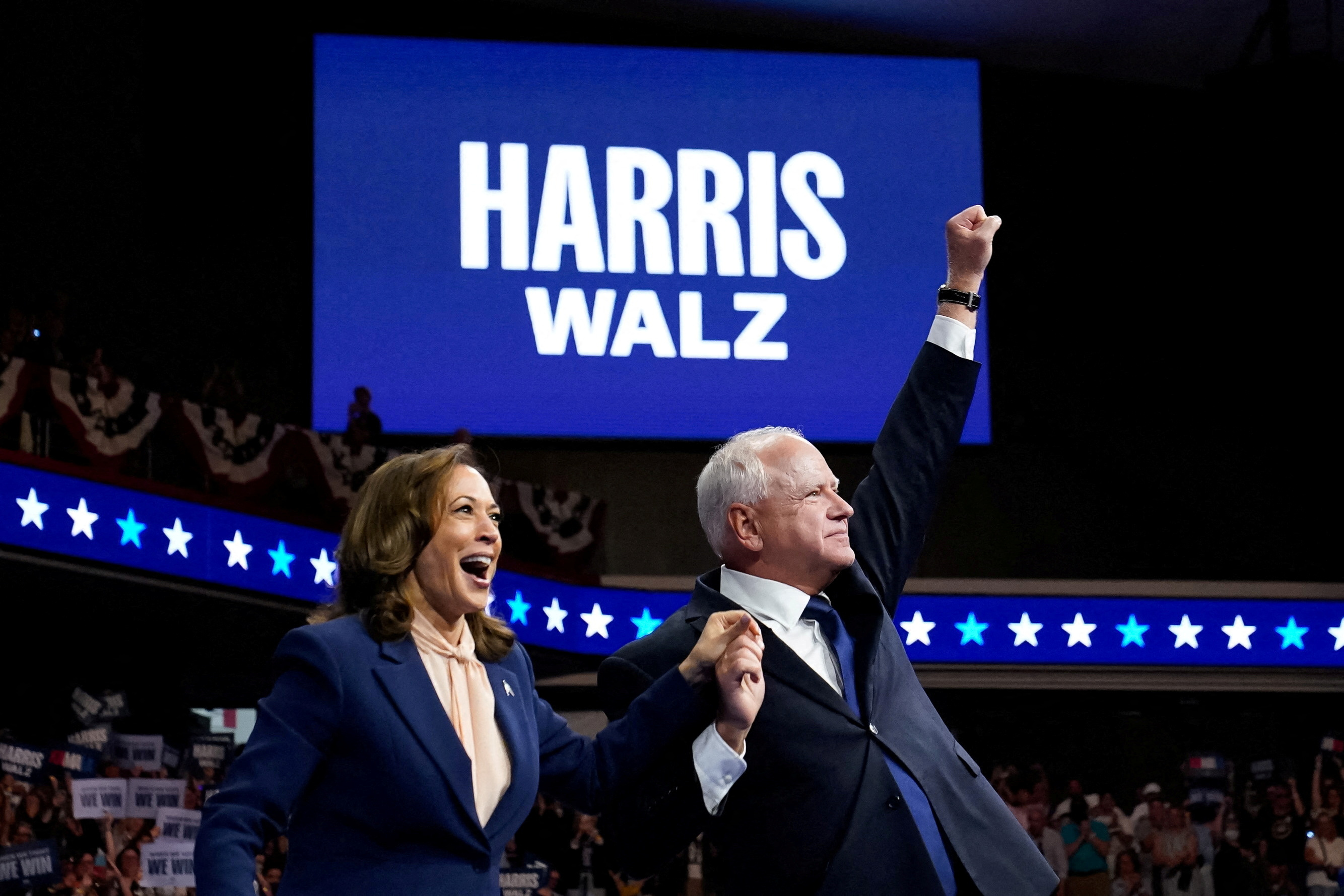 US Vice President and Democratic presidential candidate Kamala Harris and her newly chosen running mate Minnesota Governor Tim Walz react as they hold a campaign rally in Philadelphia, Pennsylvania, US, August 6, 2024 [Elizabeth Frantz/Reuters]