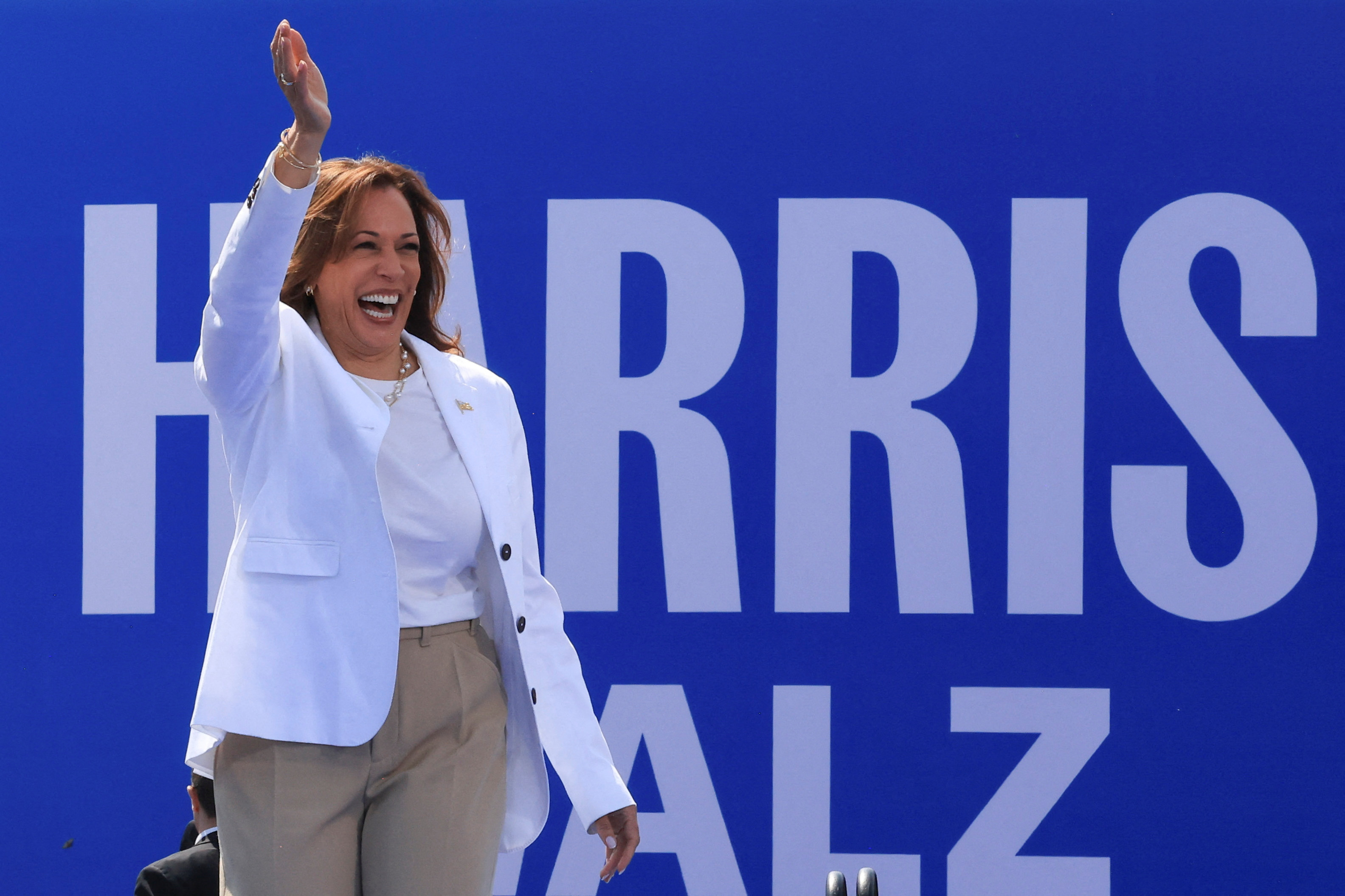 Democratic presidential candidate Kamala Harris waves