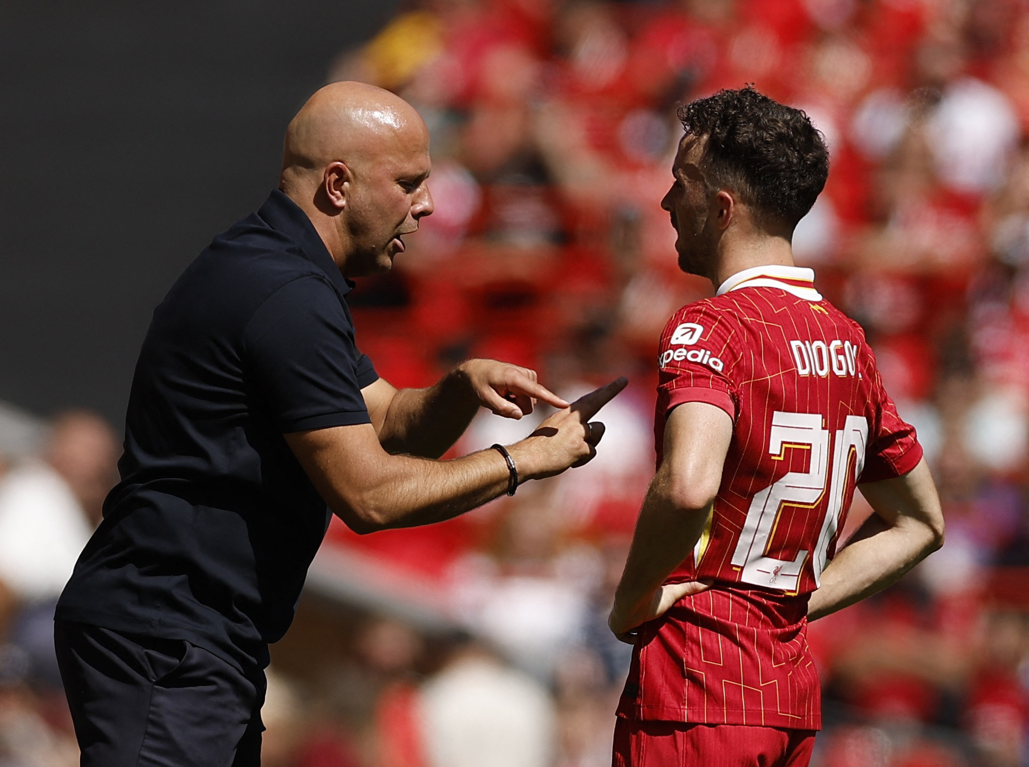 Soccer Football - Pre Season Friendly - Liverpool v Sevilla - Anfield, Liverpool, Britain - August 11, 2024 Liverpool manager Arne Slot gives instructions to Diogo Jota Action Images via Reuters/Jason Cairnduff