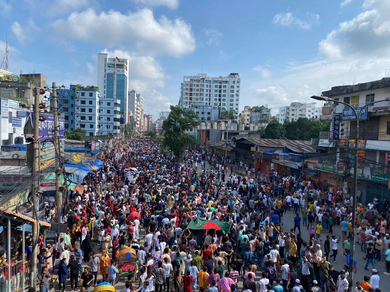 People shout slogans as they take part in a protest against Prime Minister Sheikh Hasina
