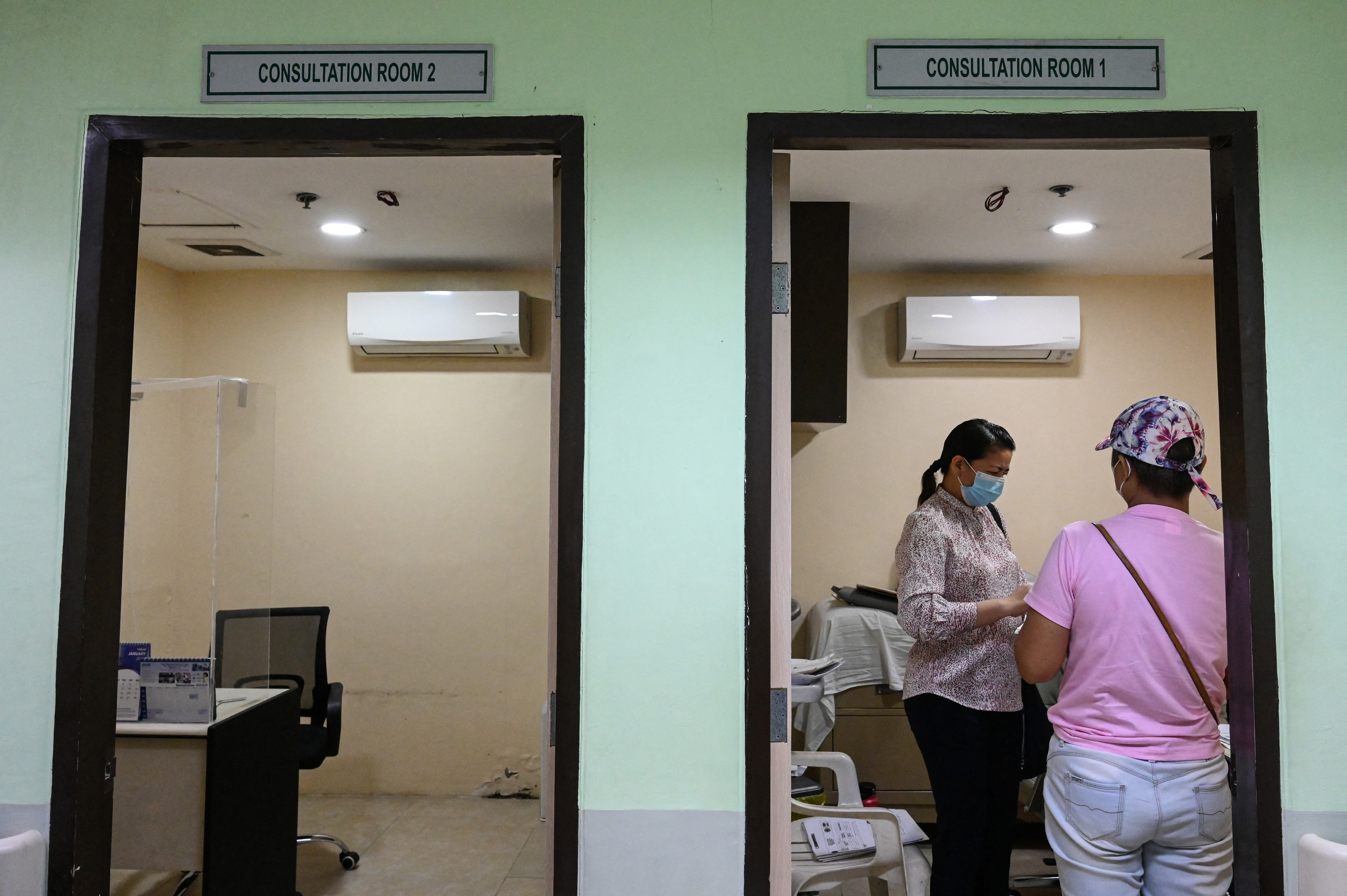 A woman queues for a consultation at a hospital in Quezon City, Metro Manila