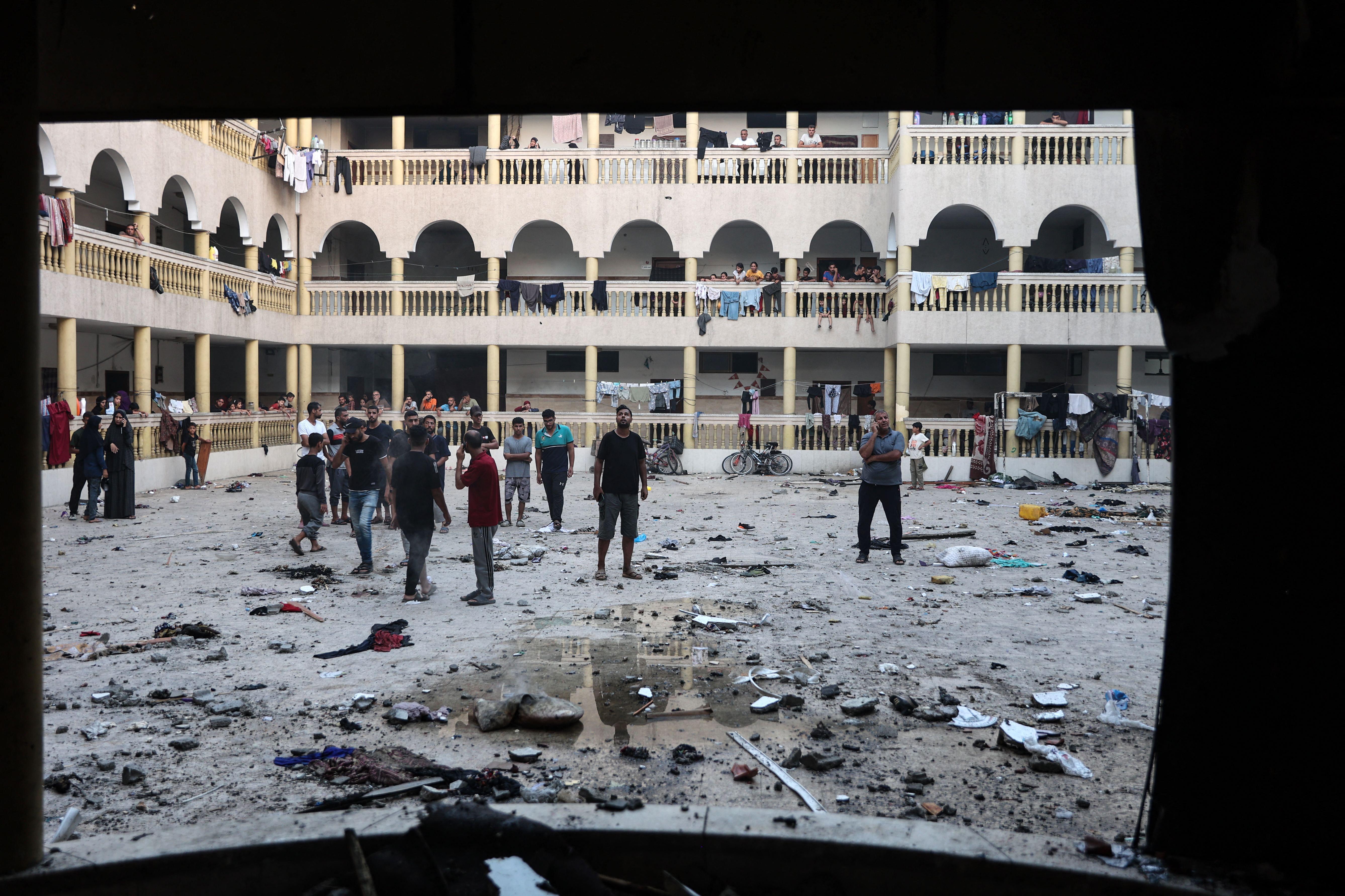 Displaced Palestinians gather in the yard of a school hit by an Israeli strike in Gaza City on August 10, 2024, that killed more than 90 people. (Photo by Omar AL-QATTAA / AFP)