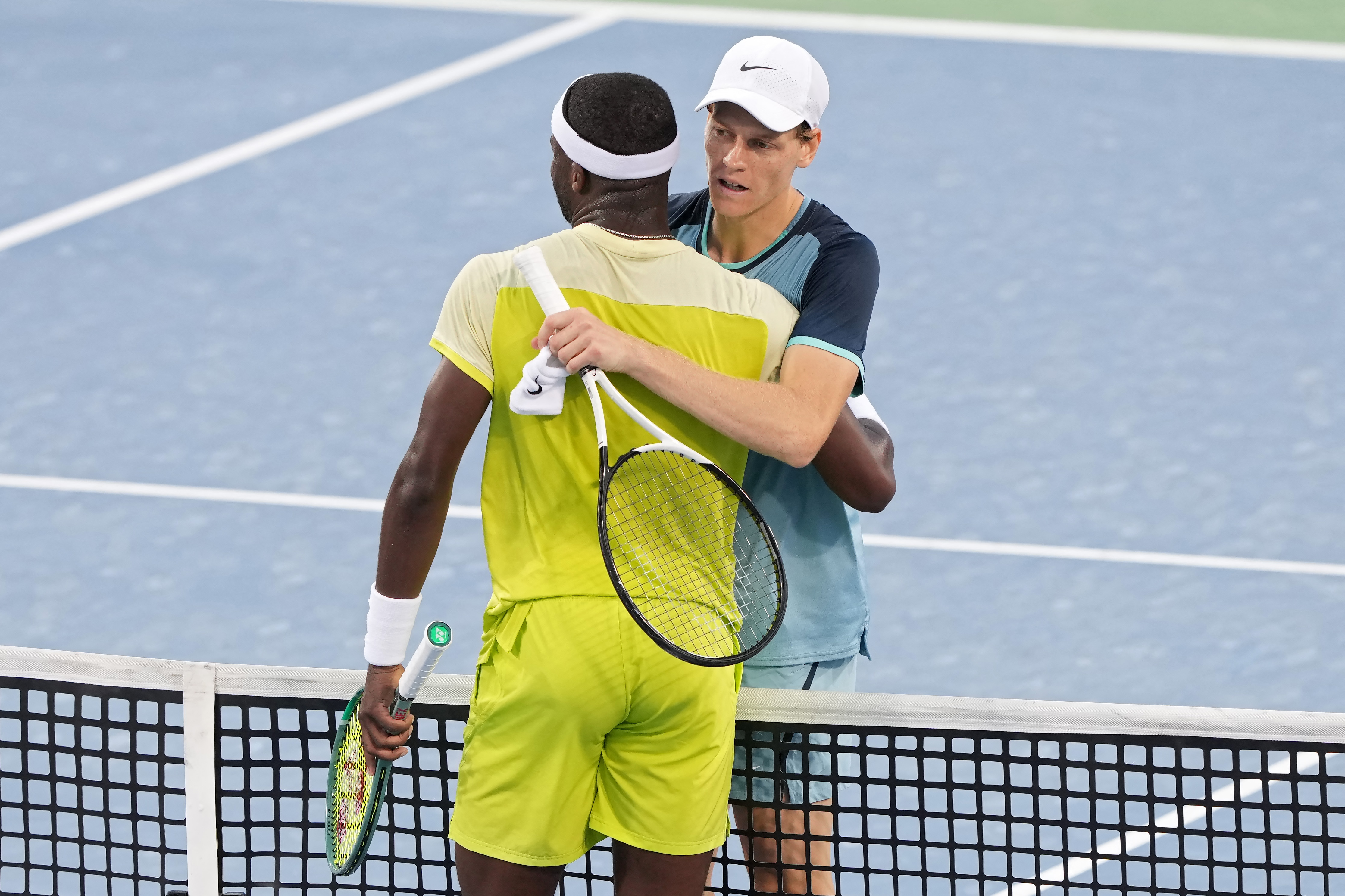 Players hug after tennis match.