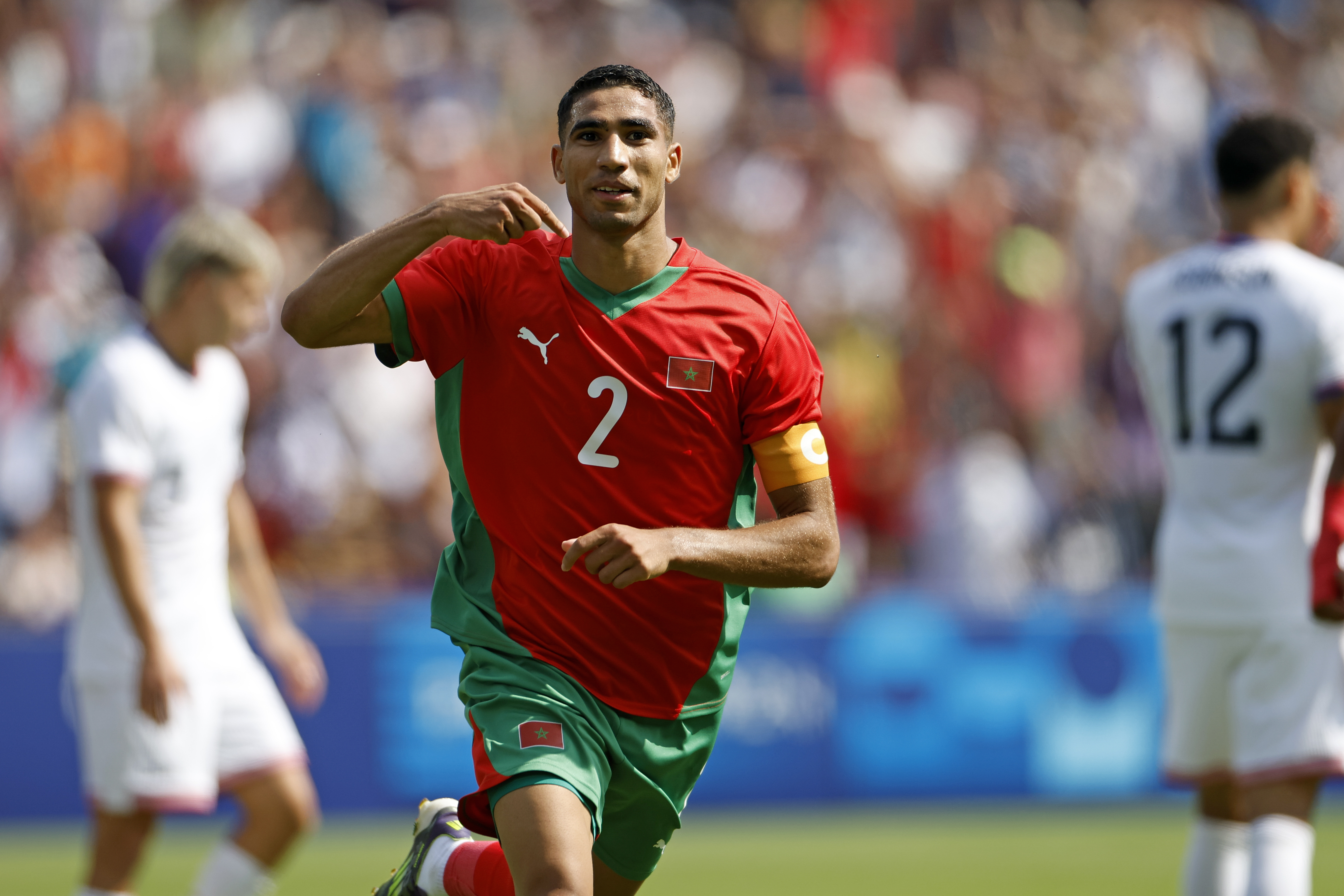 Morocco's Achraf Hakimi celebrates scoring his side's third goal during the quarterfinal men's soccer match between Morocco and the United States at the Parc des Princes during the 2024 Summer Olympics, Friday, Aug. 2, 2024, in Paris, France. (AP Photo/Aurelien Morissard)