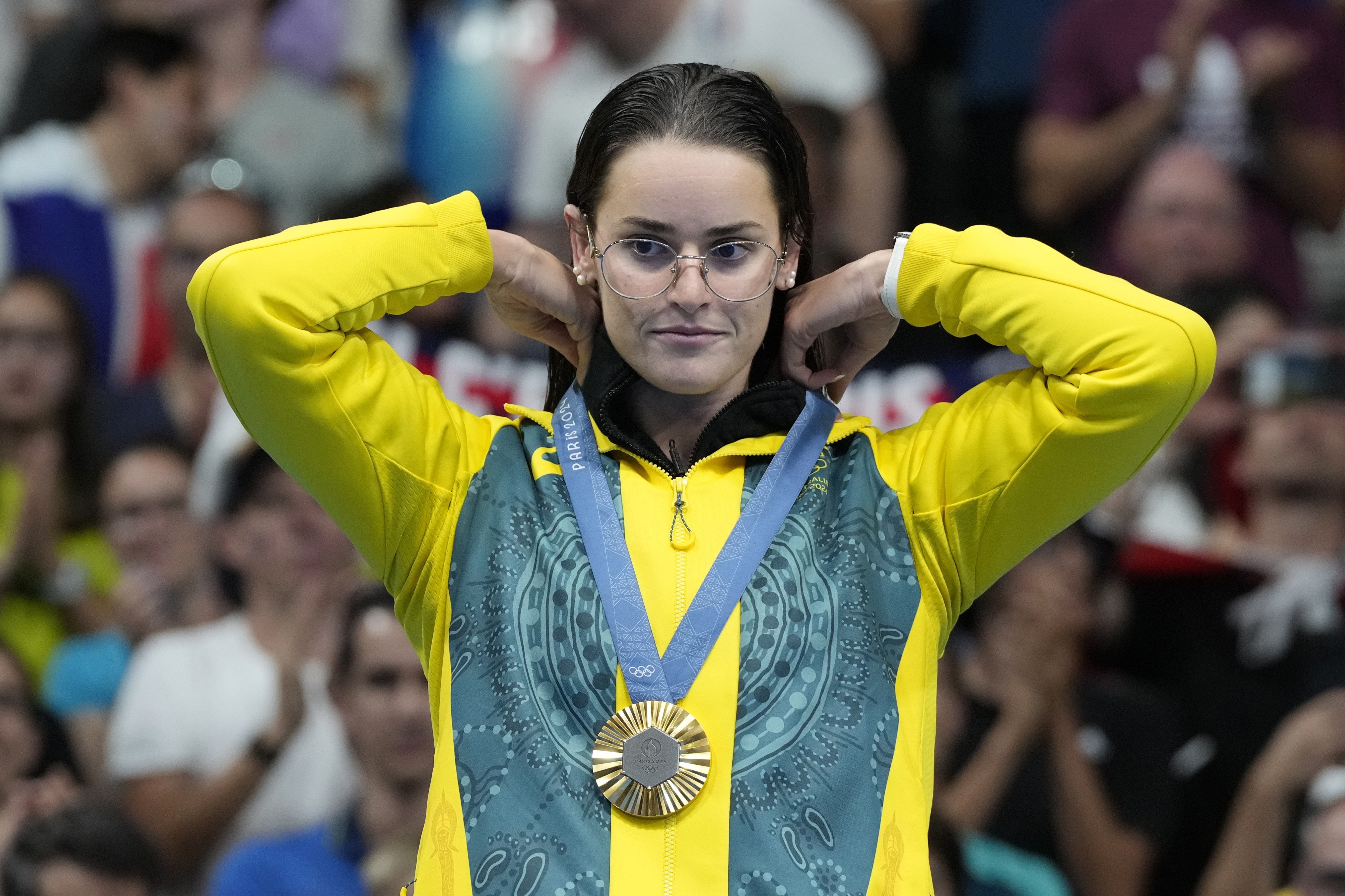 Kaylee McKeown of Australia, reacts after receiving her gold medal in the women's 200-meter backstroke final at the 2024 Summer Olympics, Friday, Aug. 2, 2024, in Nanterre, France. (AP Photo/Natacha Pisarenko)